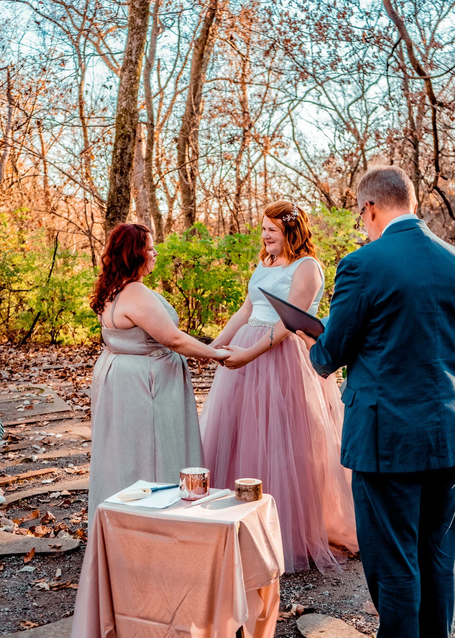 A glimpse of the beautiful brides, caught over the pastor's shoulder.