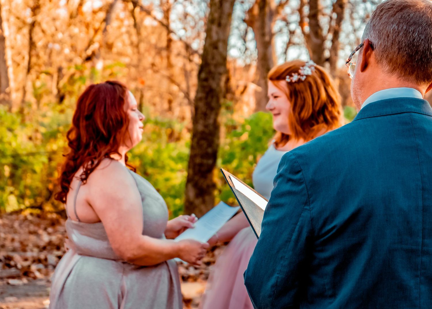 Brides exchanging vows in the center of a leafy stone maze.