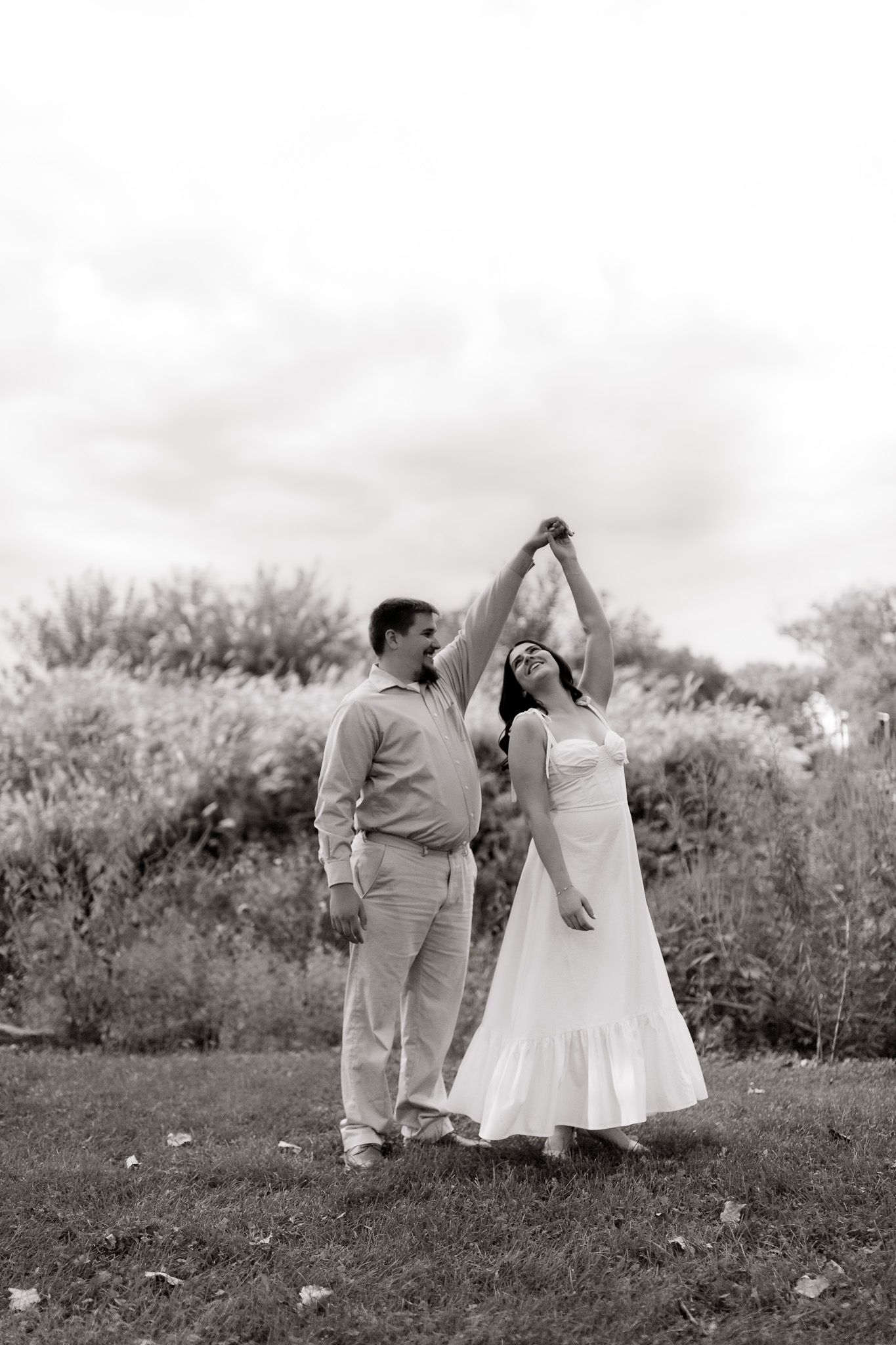 Engagement photography of a couple laughing and enjoying their session, photographed by Jessica Rose Photography, Janesville WI.