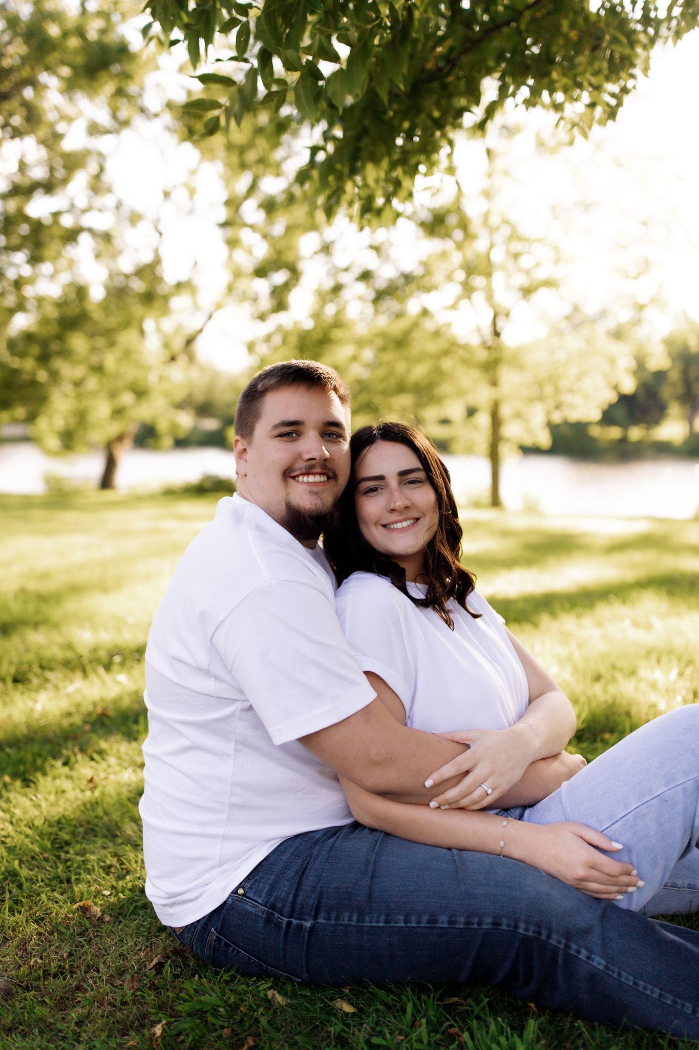 Couple sitting and smiling during their engagement photo session, captured by Jessica Rose Photography in Janesville, Wisconsin.