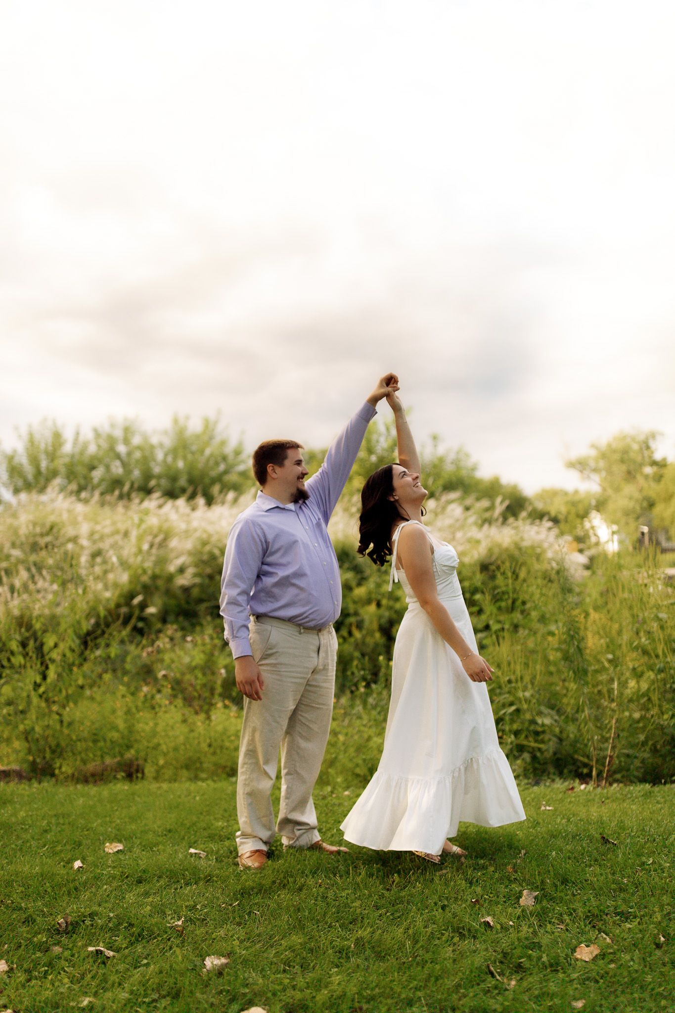 Engagement photography of a couple laughing and enjoying their session, photographed by Jessica Rose Photography, Janesville WI.