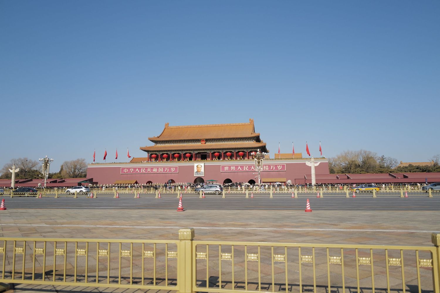 Tiananmen Gate entrance to the Forbidden City with yellow barriers in the foreground.