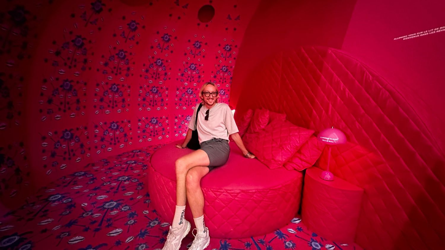 Red neon-lit interior room with geometric pattern projections.