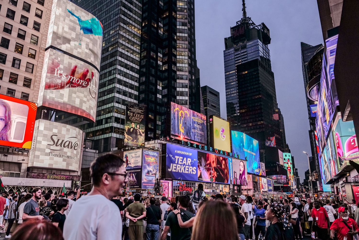 Times Square at night illuminated by vibrant digital billboards and neon signs.