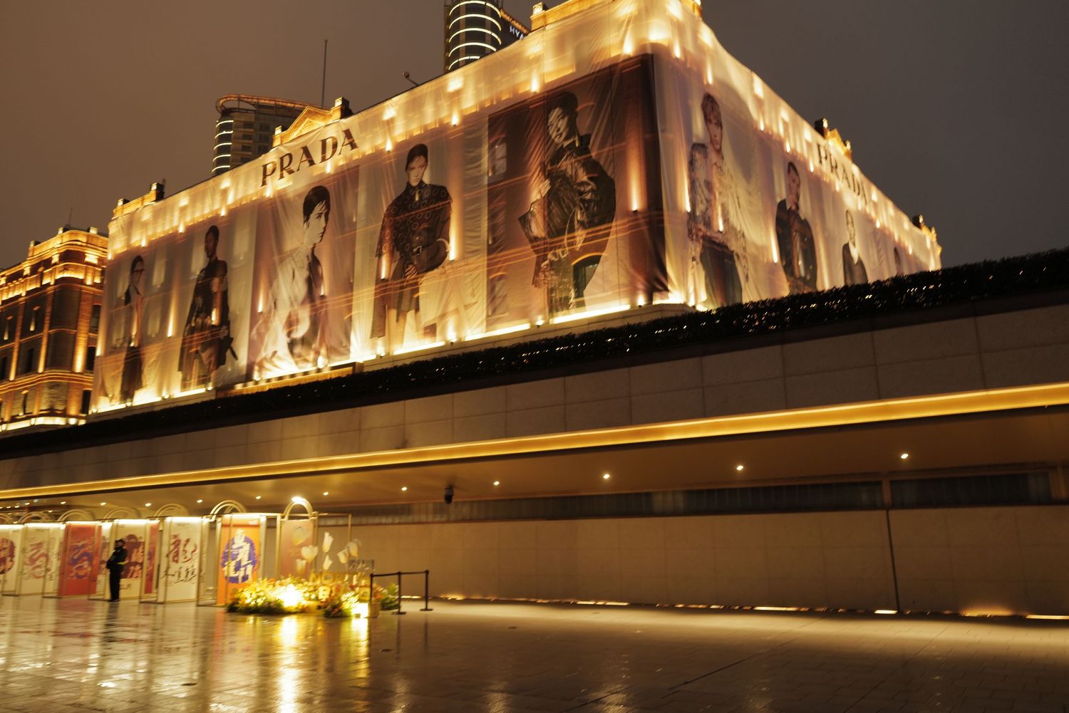 Elegantly lit historic building facade along the Bund in Shanghai at night.