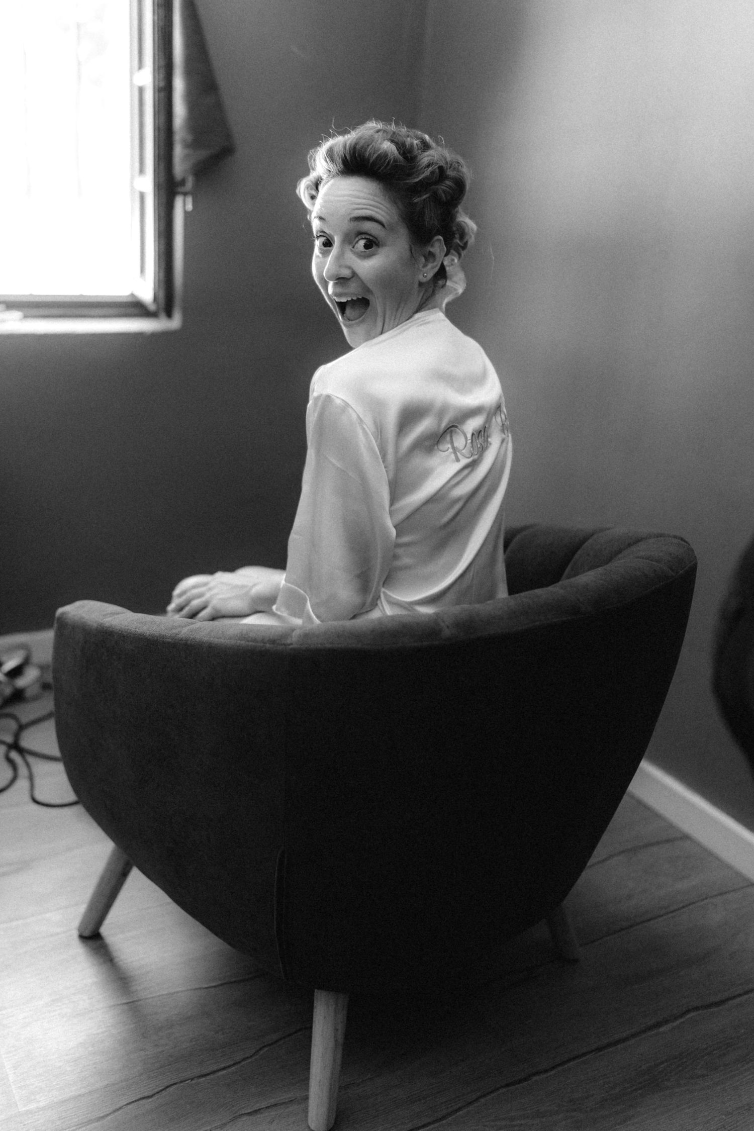 Artistic black and white portrait series on a dark couch.