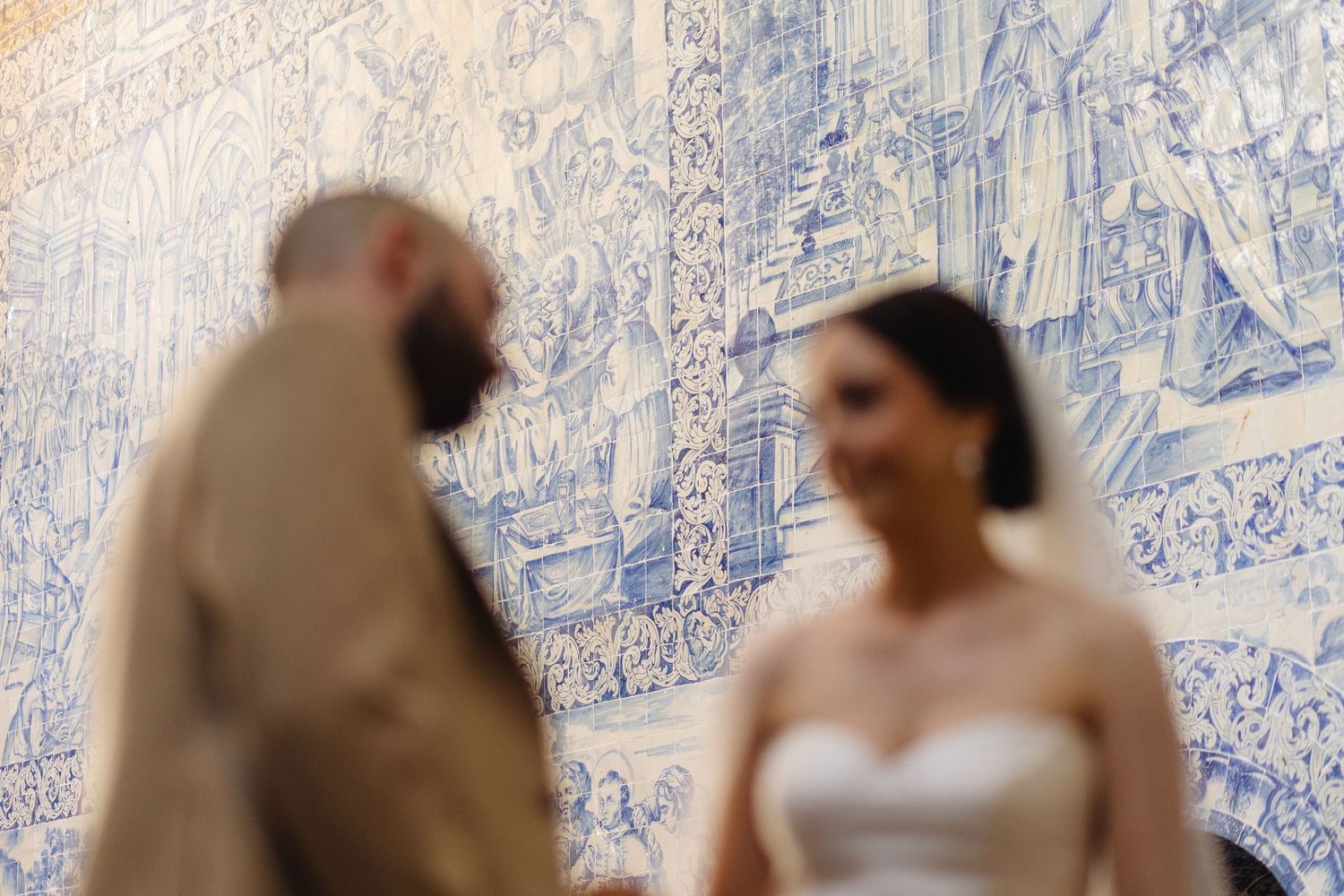 Wedding ceremony in historic Portuguese chapel showcasing traditional blue tile artwork.