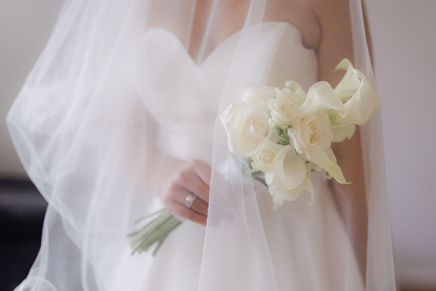 Delicate white orchids adorn a bridal gown in elegant detail.