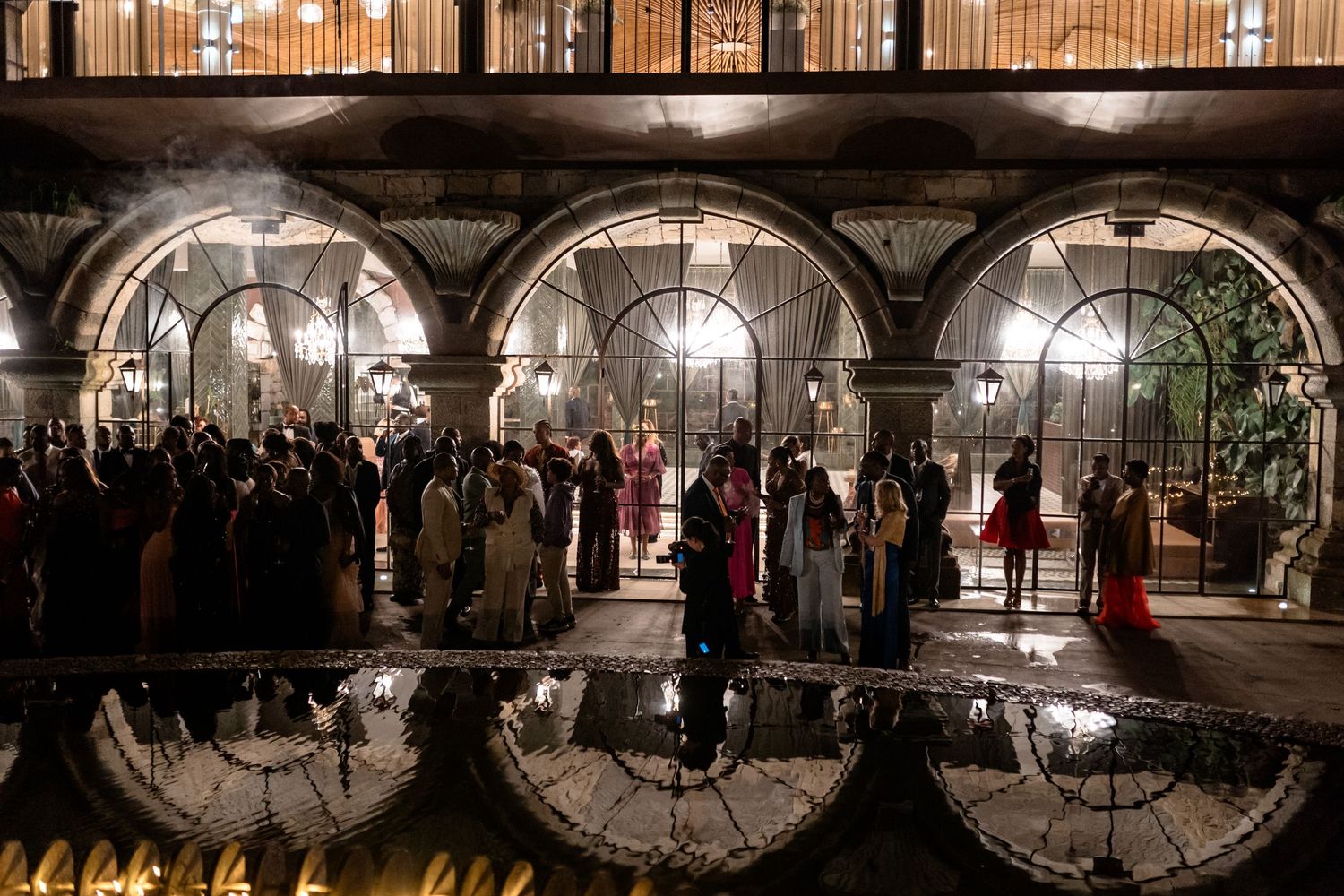 Dark archways and dramatic lighting create a moody atmosphere in a historic venue.
