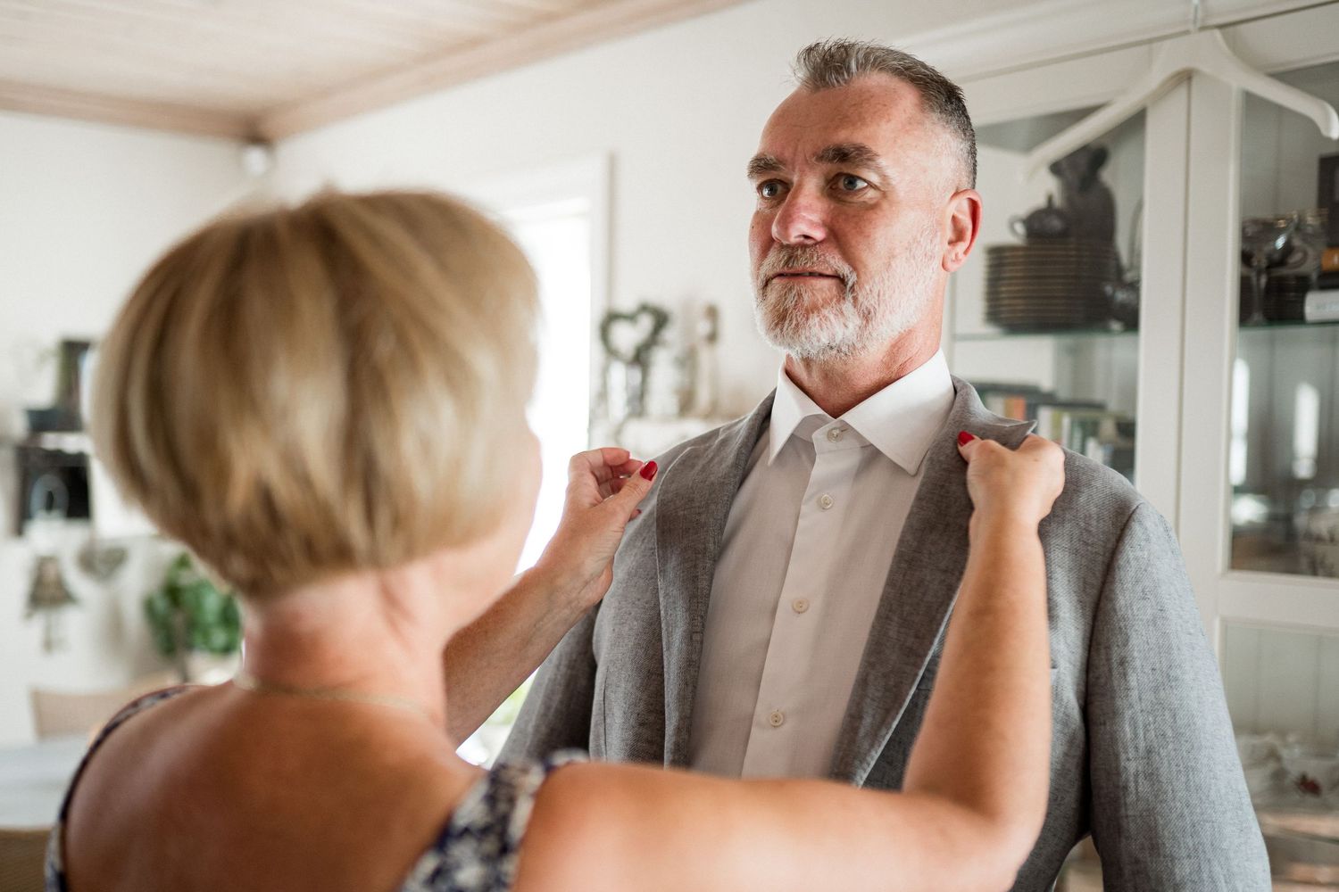 A couple shares an intimate moment during their wedding day celebration in an elegant indoor setting.