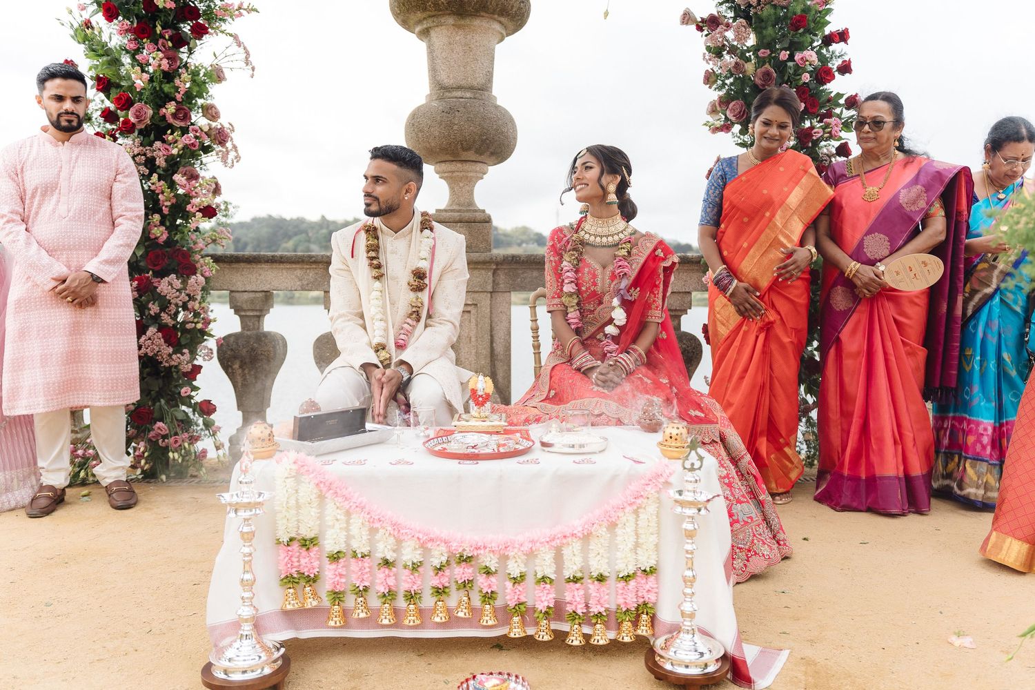 Wedding venue decorated with pink fabric and floral arrangements.