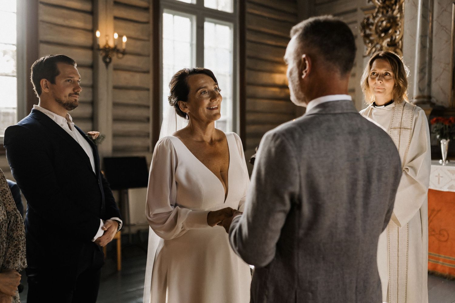 Wedding celebration candid moments in a rustic wooden interior.