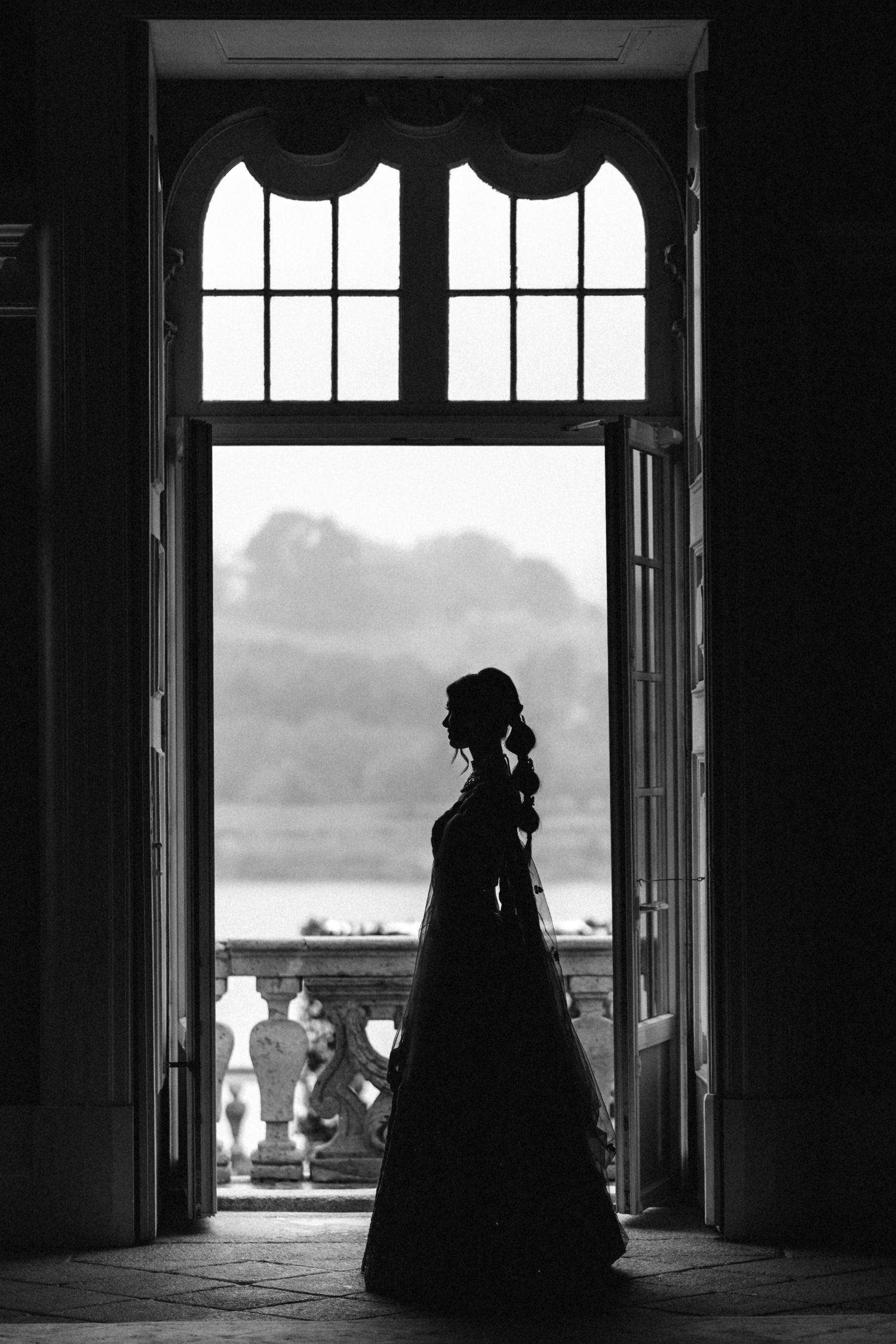 A series of black and white silhouettes in doorways showing figures in Victorian-era dress against bright windows.