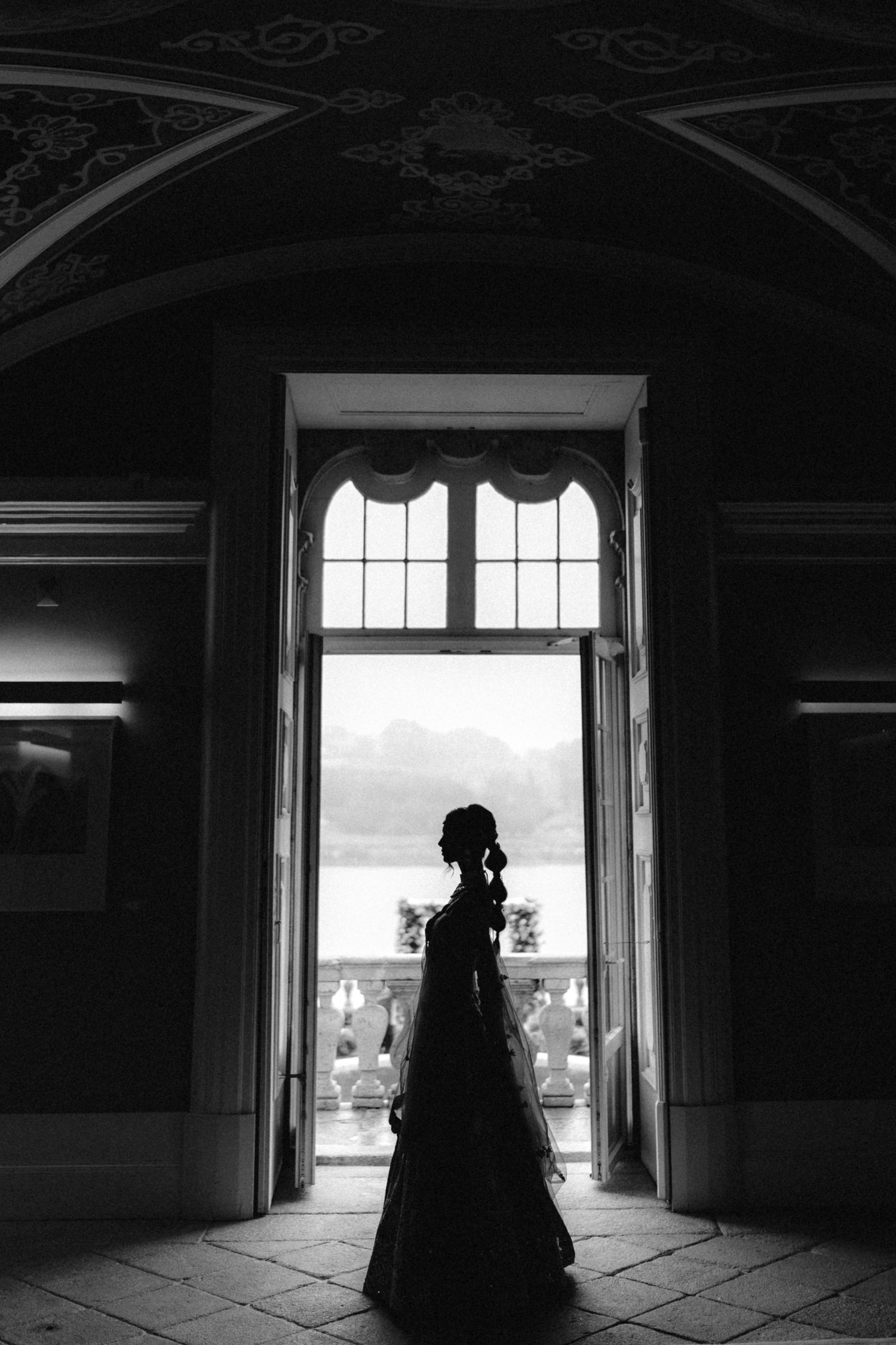 Dramatic silhouette portraits through doorway in black and white.