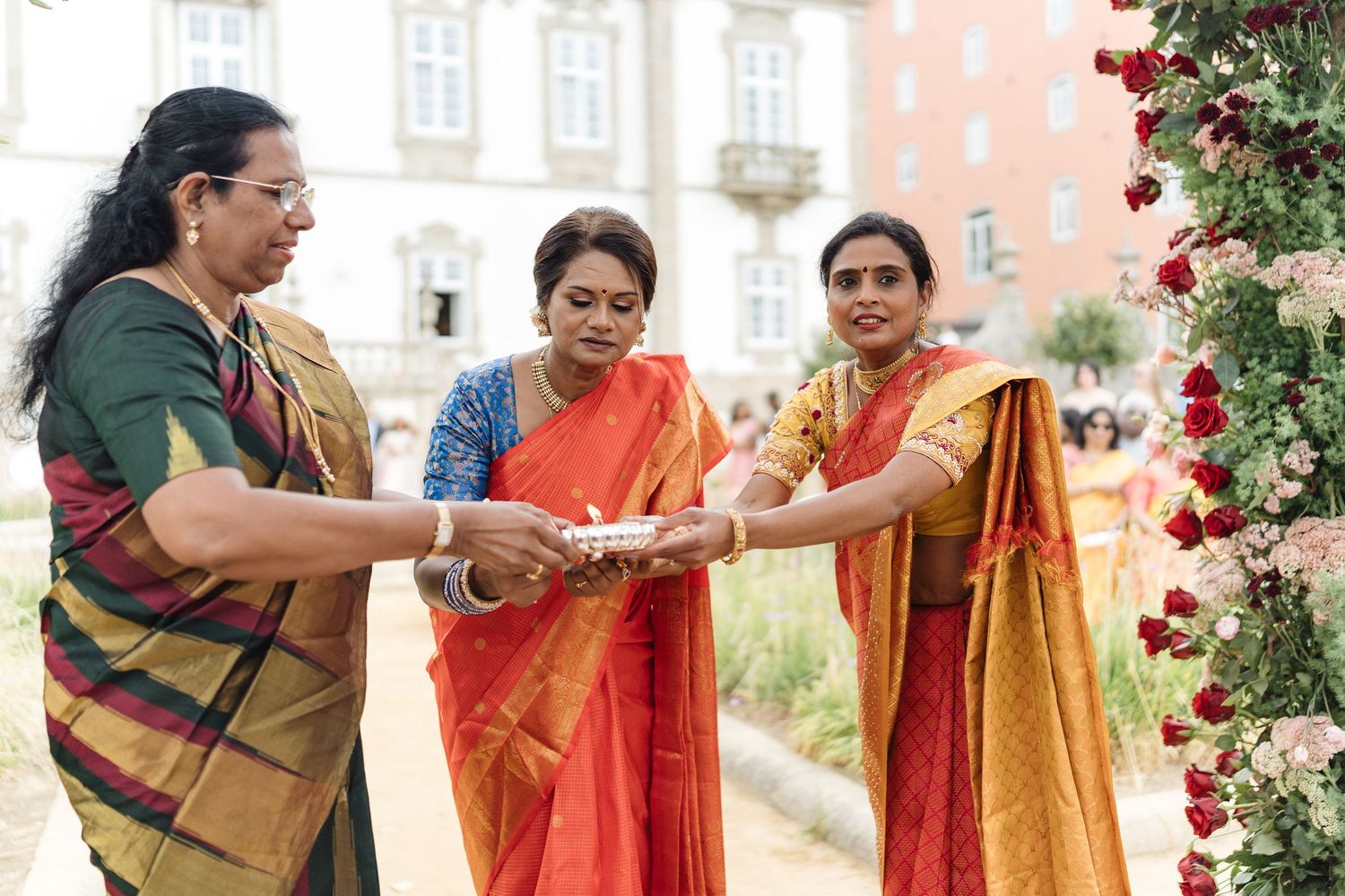 Traditional Indian wedding ceremony with red roses and decorative elements in an outdoor setting.