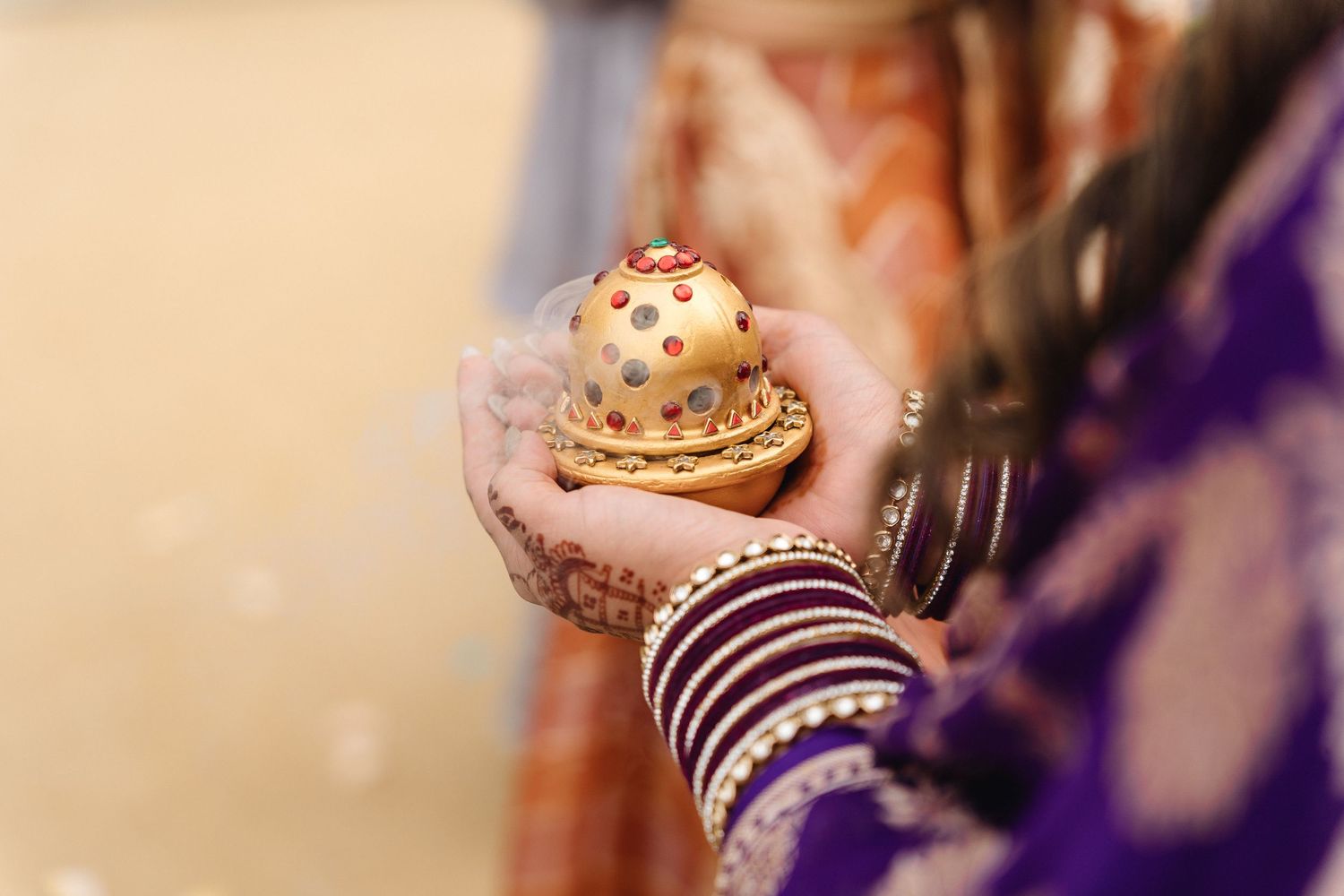 Close-up of decorative bangles and jewelry worn during traditional Indian wedding ceremony.