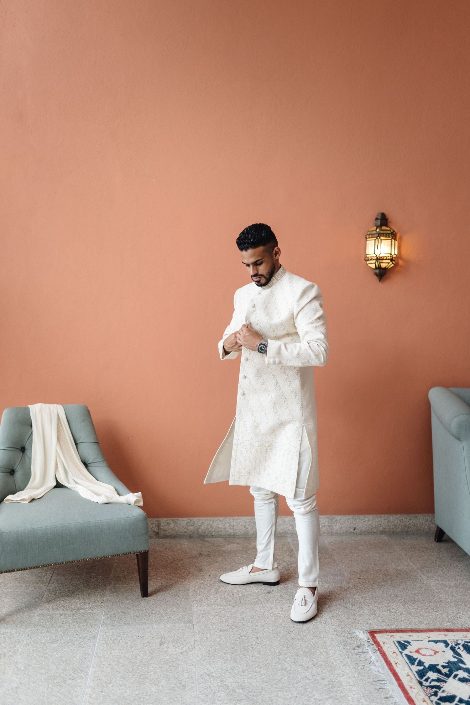 A sequence of photos showing someone in white attire against a terracotta wall with a blue chair.