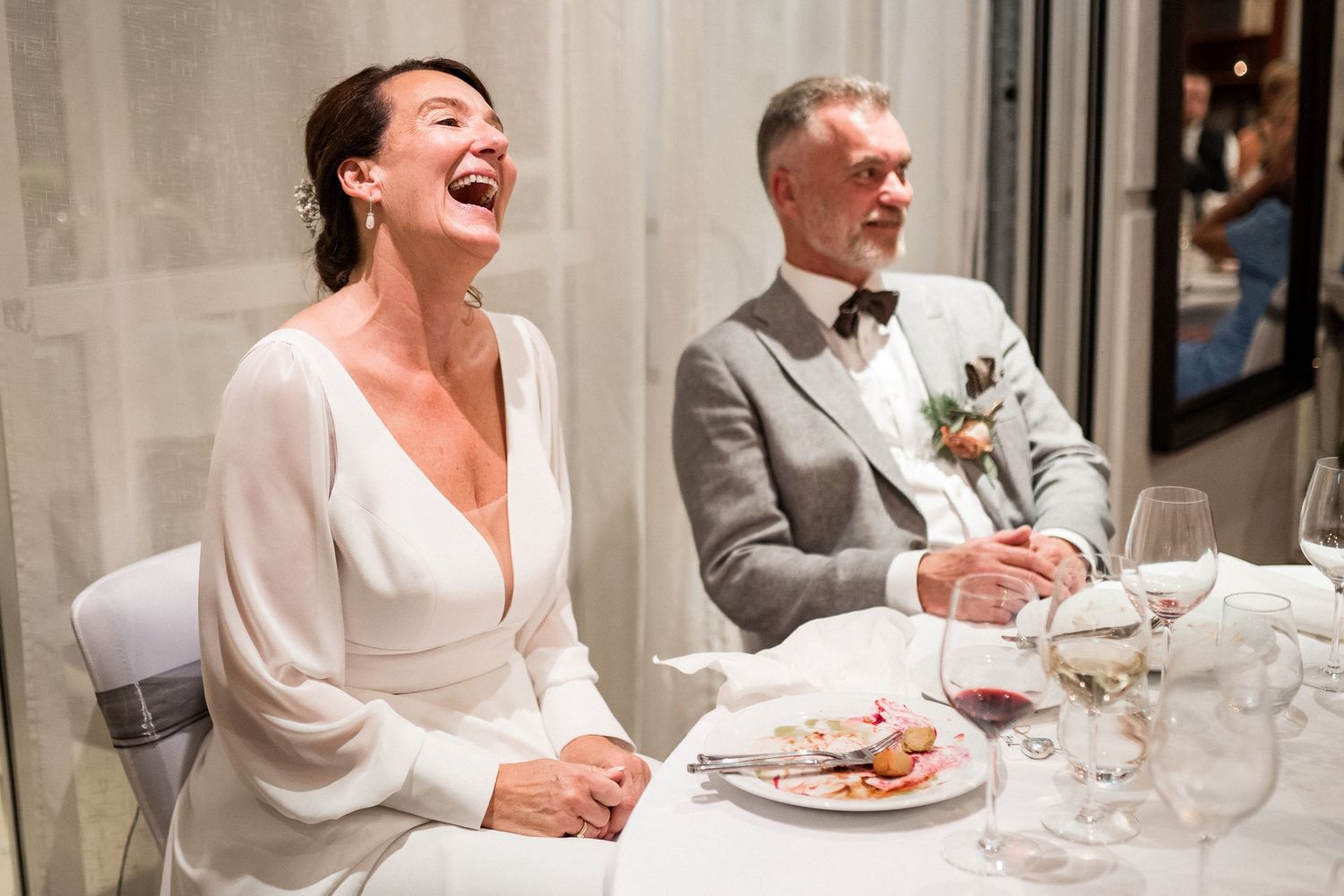 Wedding reception dinner scene with elegant table settings and joyful moments.