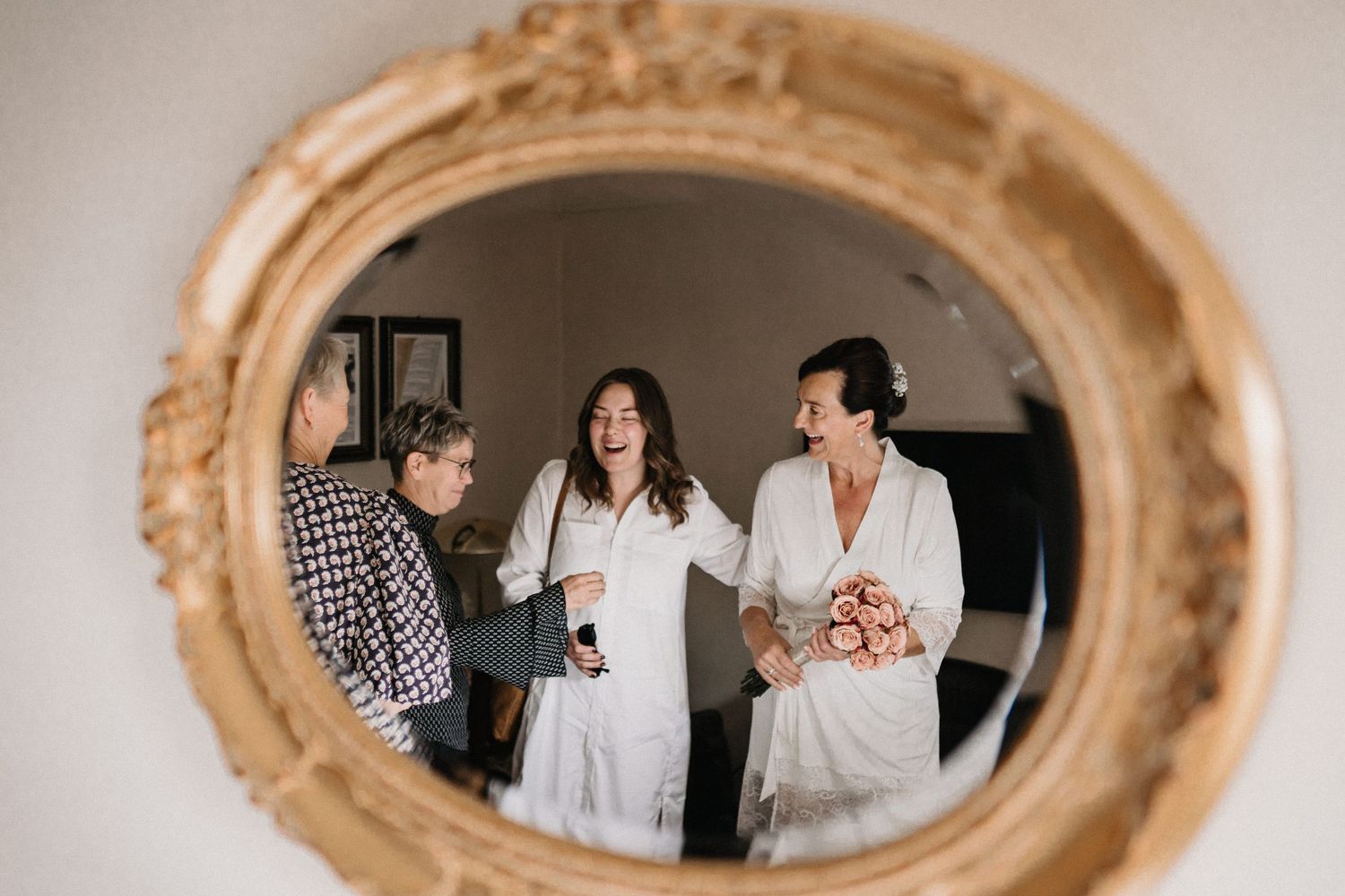 A series of reflections in an ornate gold mirror showing people getting ready.