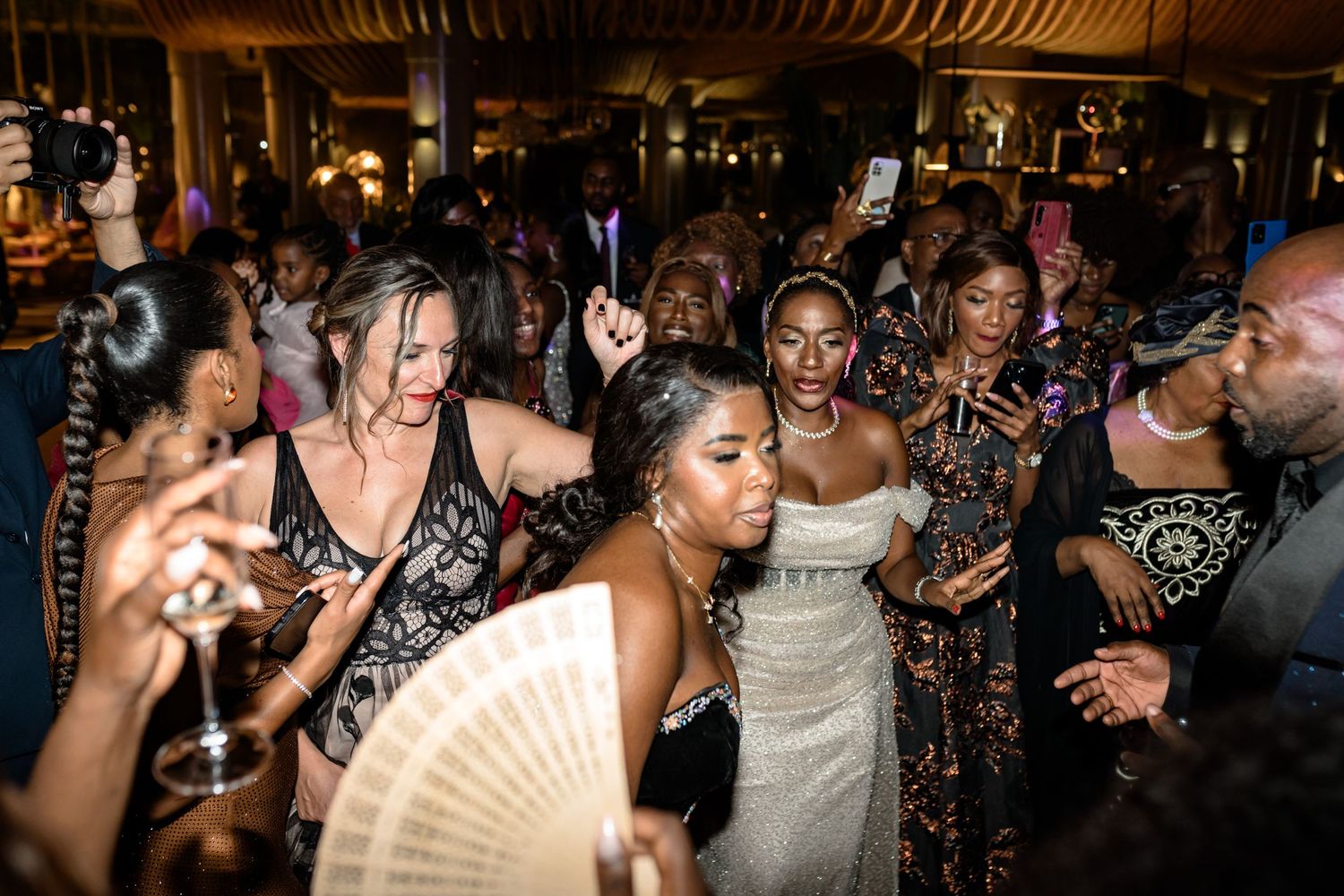 Energetic dance party scene with guests celebrating in formal attire.