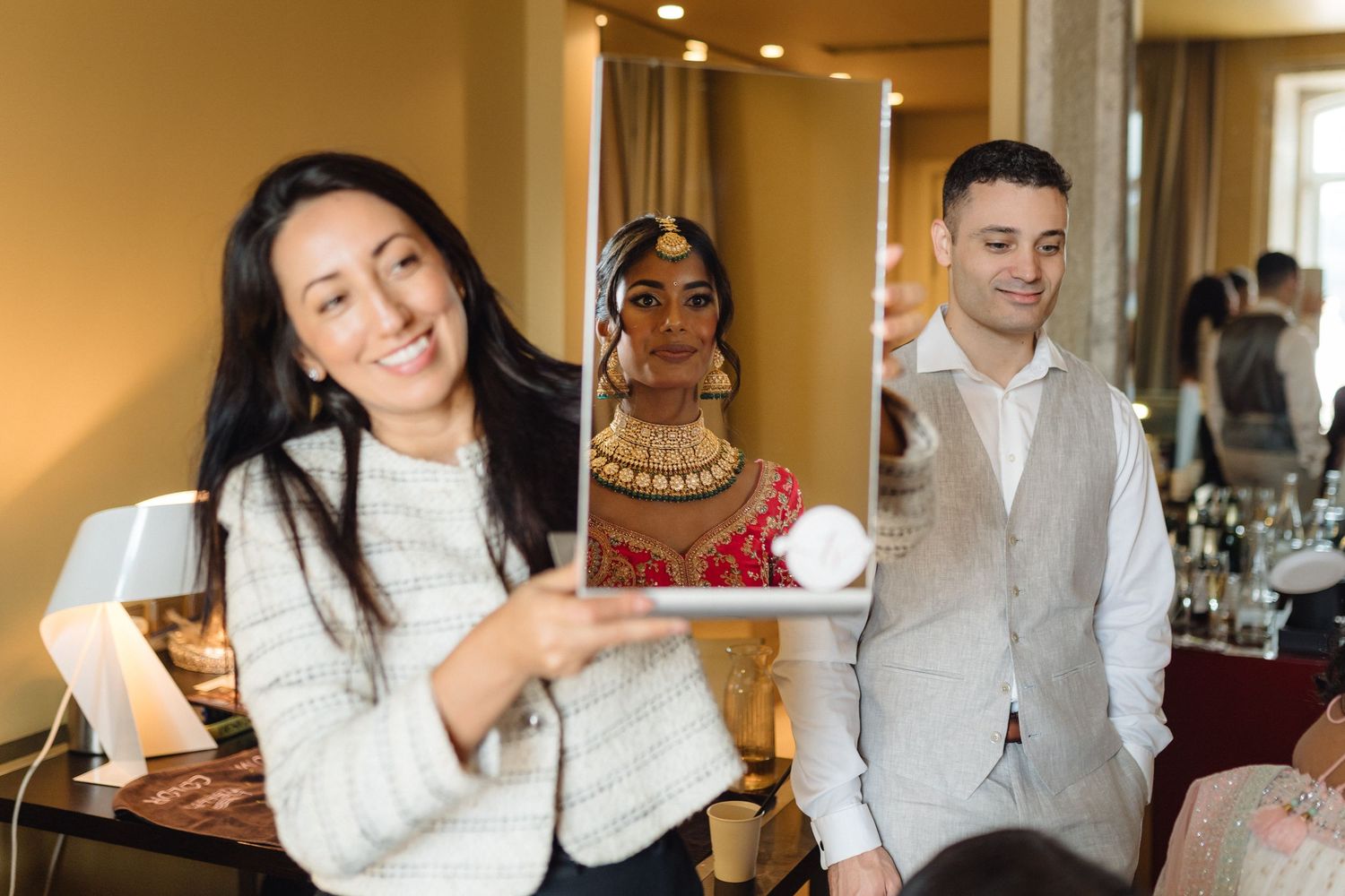 Candid moments captured during wedding preparations with guests in formal attire.