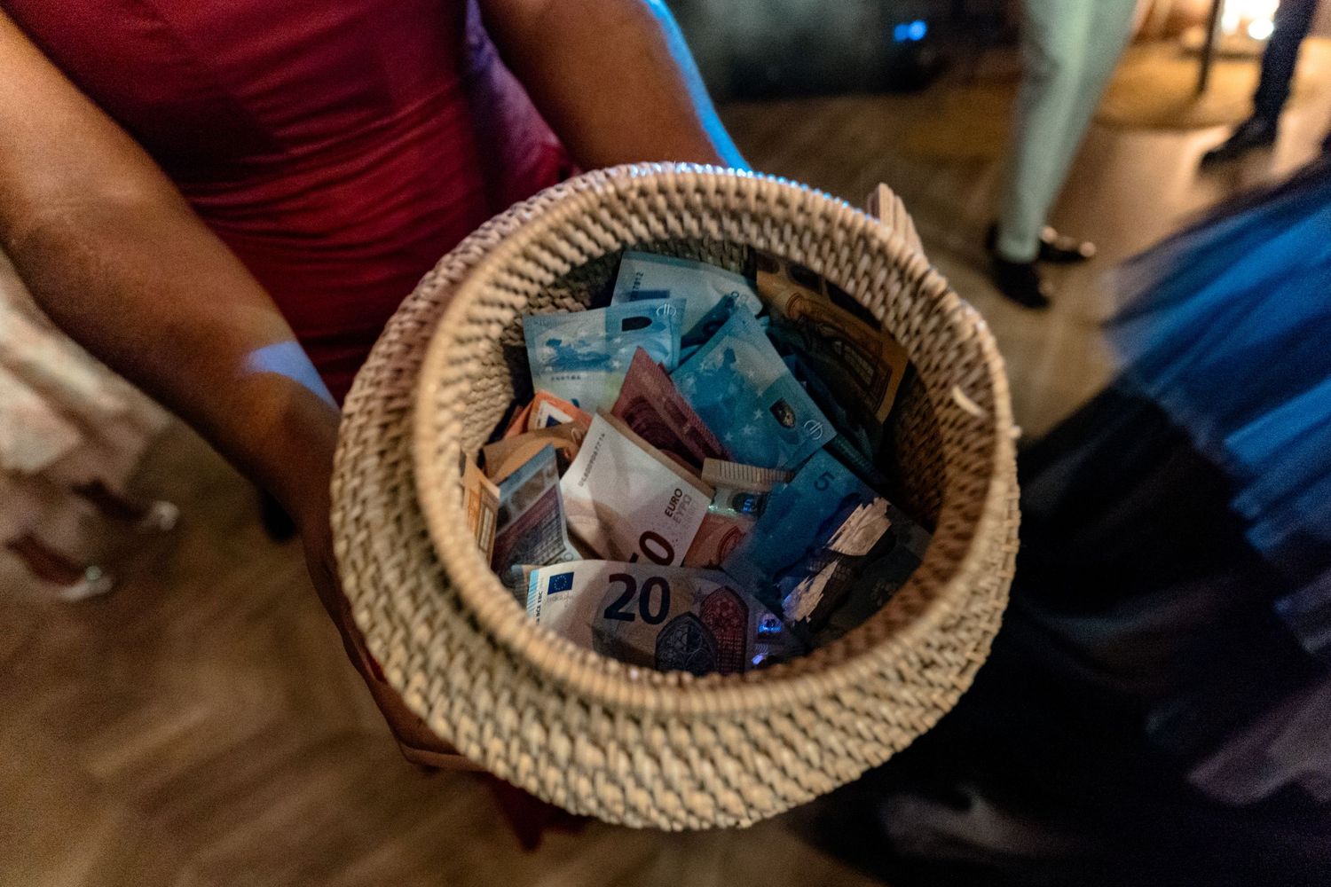Woven basket filled with blue party favors or gifts.