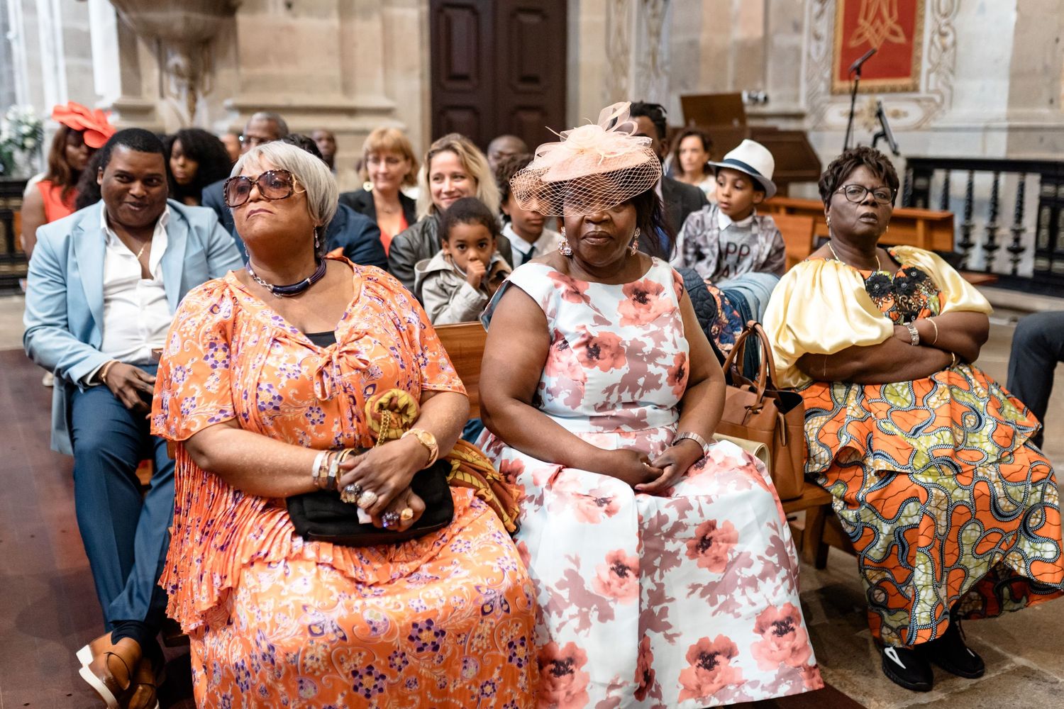 Wedding guests in colorful floral dresses enjoying an outdoor celebration.