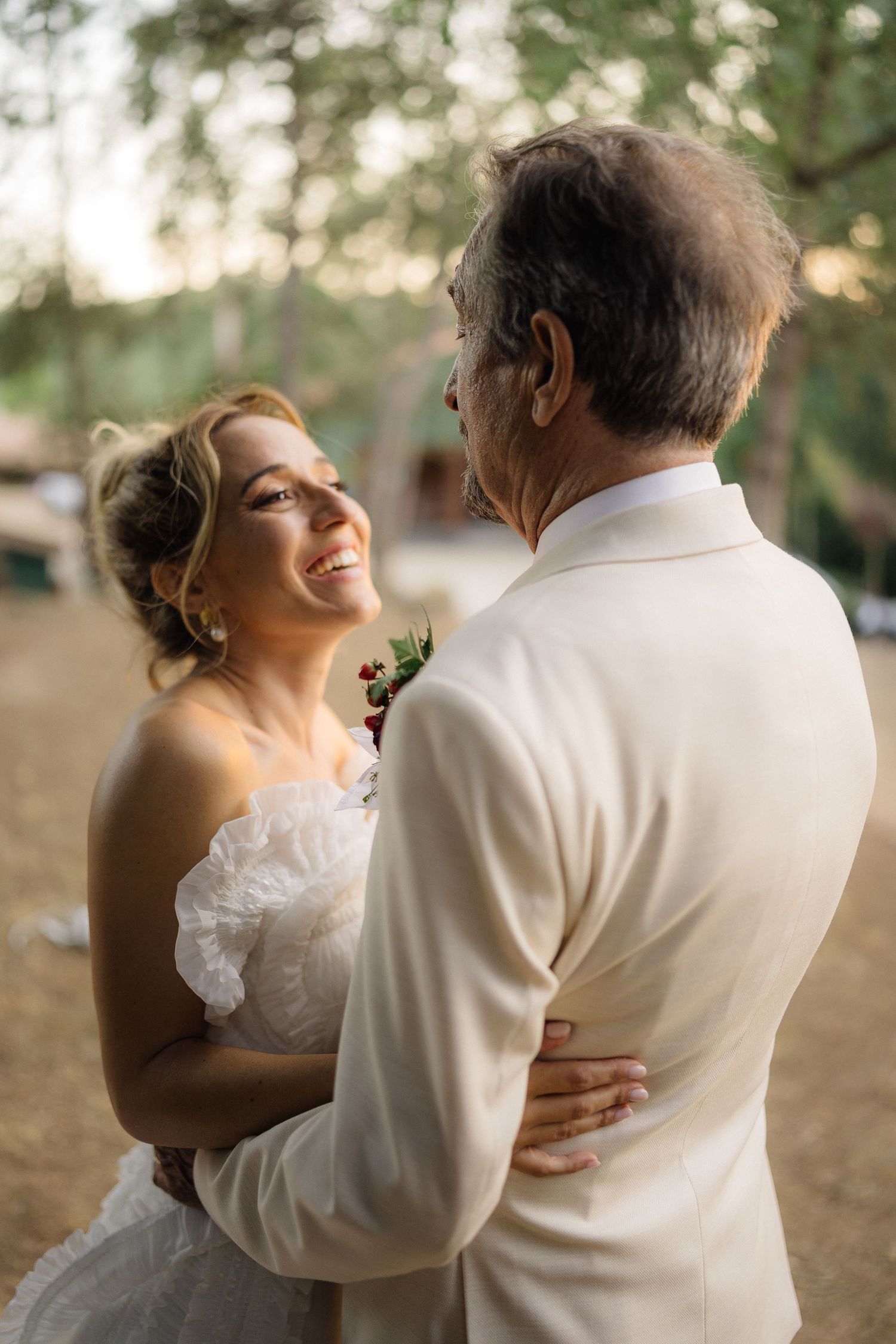 Romantic dance sequence captured in warm evening light at an outdoor wedding.
