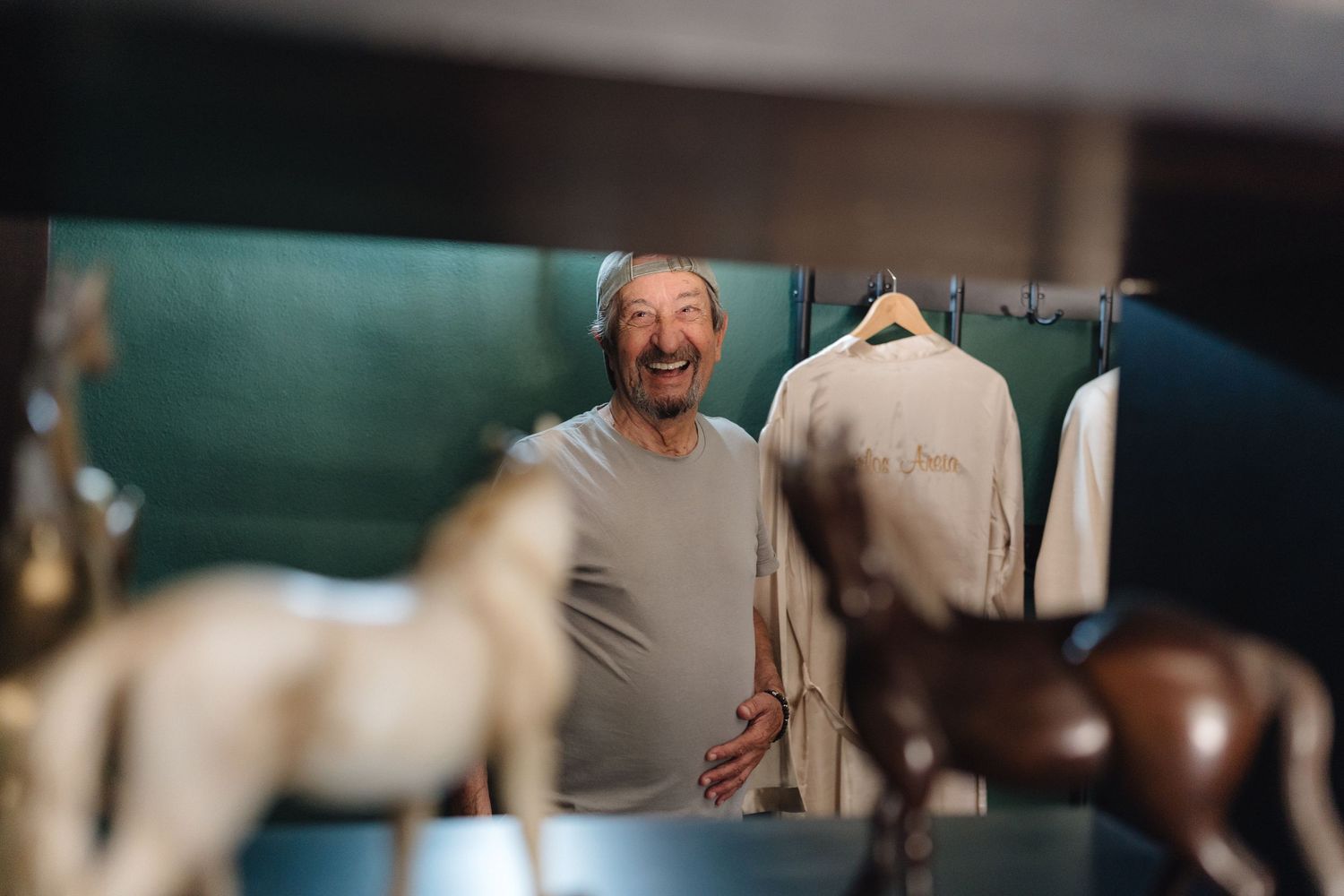 Wedding preparation scene with cream colored formal wear in dressing room.