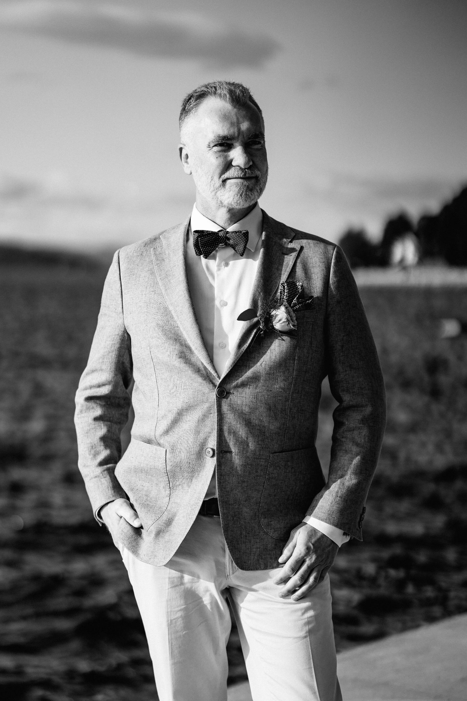 Black and white portrait series showing elegant formal attire by the water.