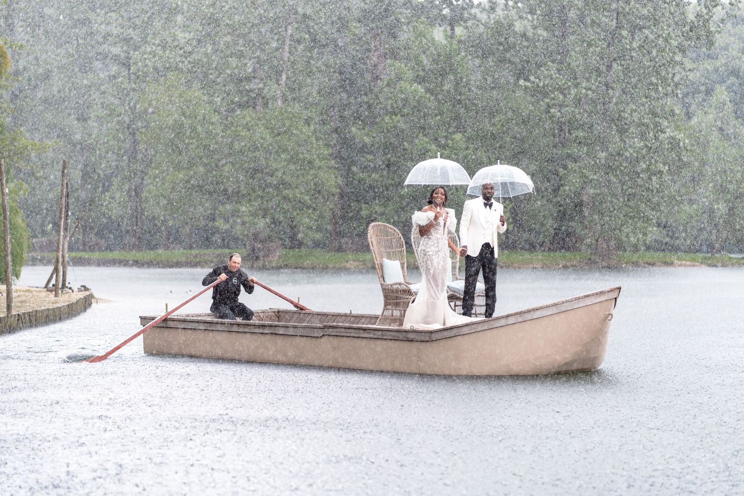 Small boats navigate through flooded streets during high water conditions in an urban area.