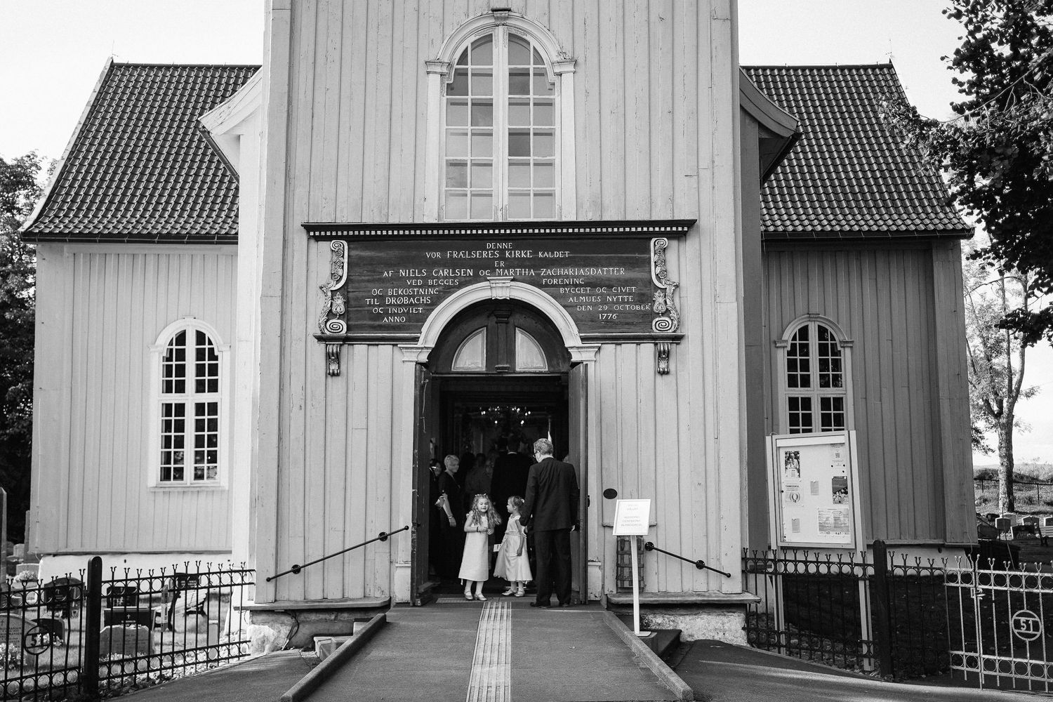 Series of exterior shots showing a white wooden church building with traditional Nordic architecture.