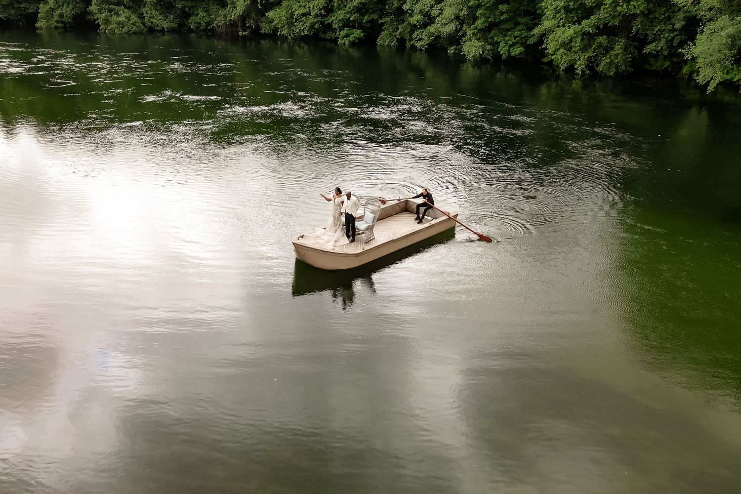 A romantic boat ride across a serene lake surrounded by lush greenery.