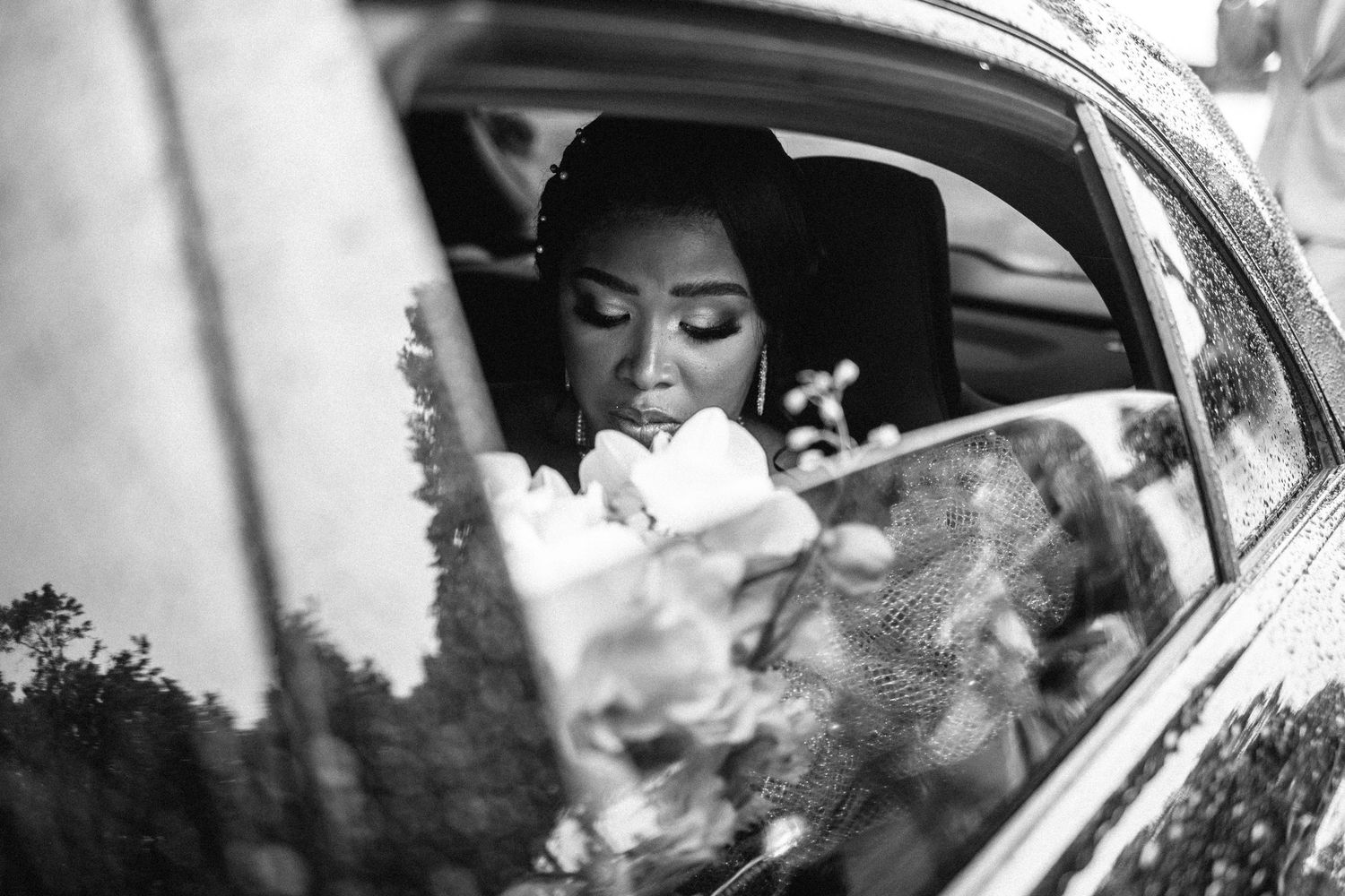 Black and white photo of vintage car on wedding day.