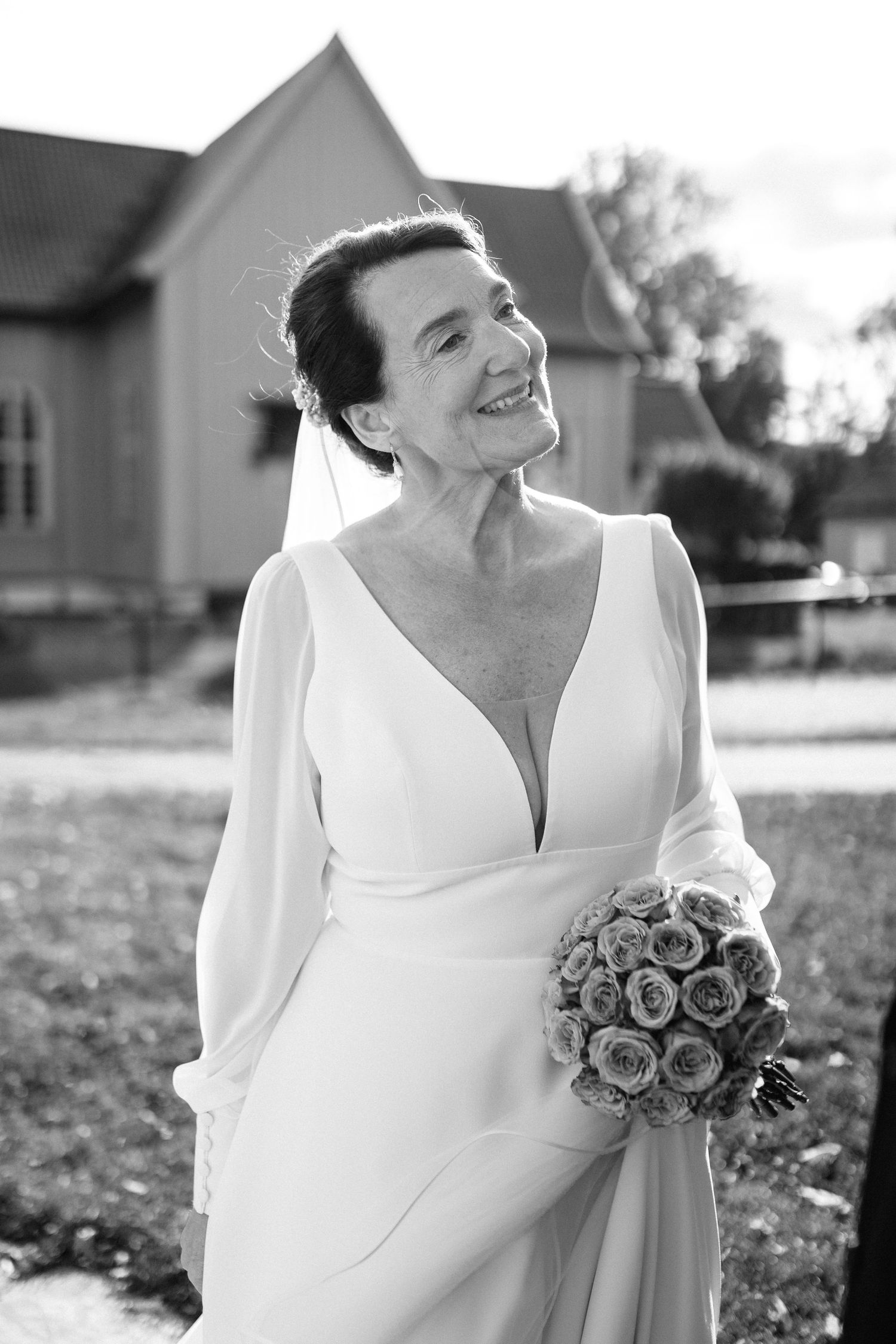 Black and white portrait series showing a bride in an elegant white dress holding a rose bouquet.