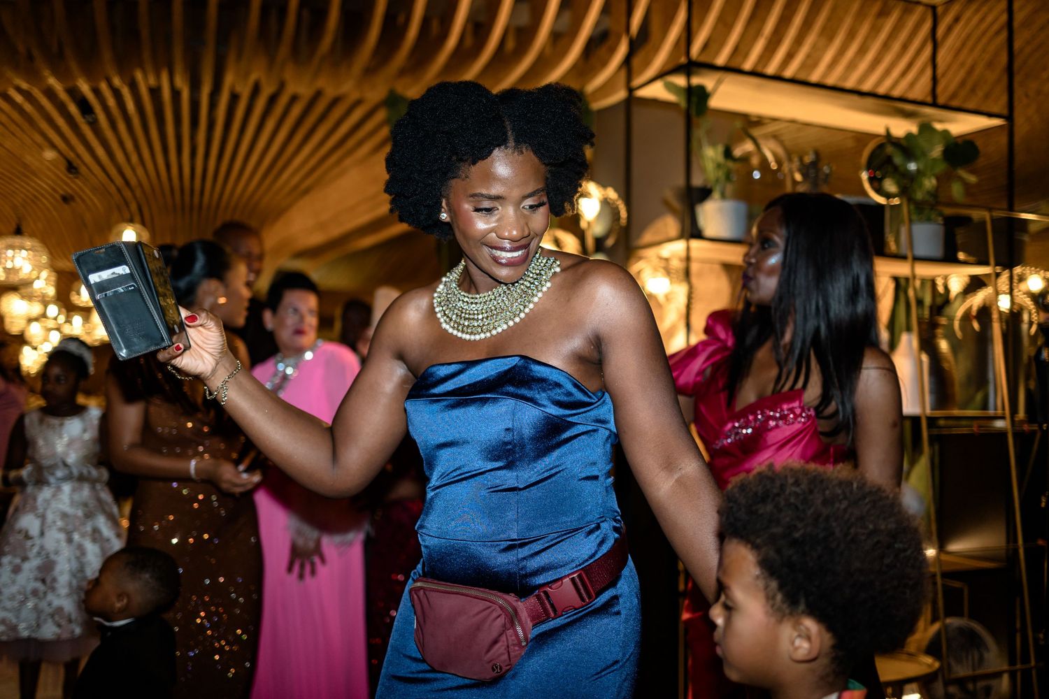 Wedding celebration with guests dancing in colorful formal attire.