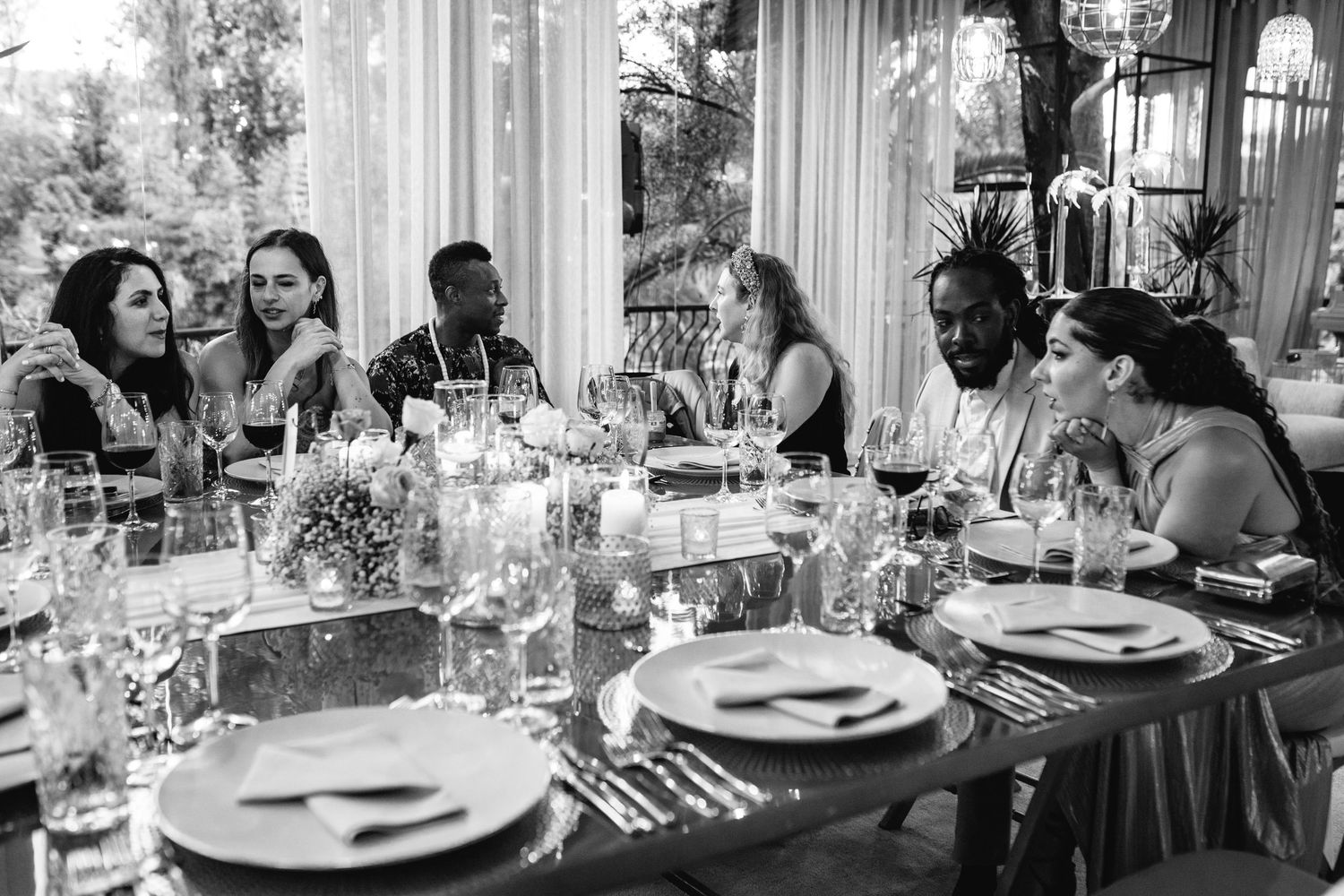 Black and white photos capture wedding reception guests dining at elegant tables.