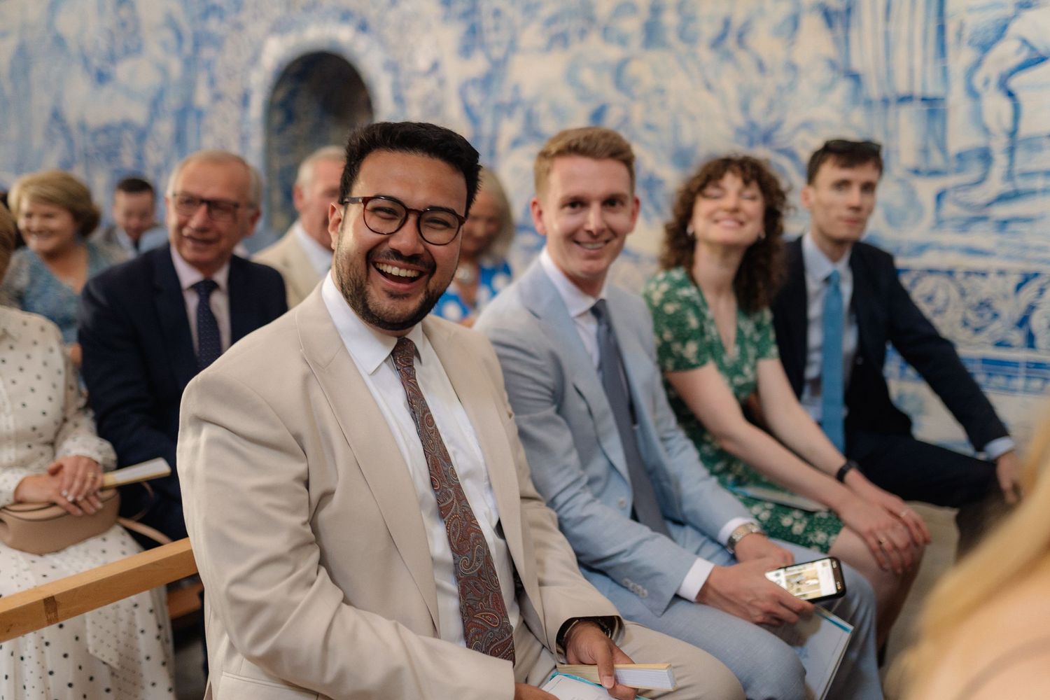 Wedding reception with blue and white decorative wall panels in the background.