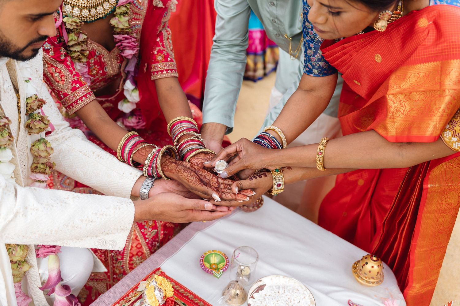 Traditional Indian wedding ceremony rituals being performed with decorative items and offerings.