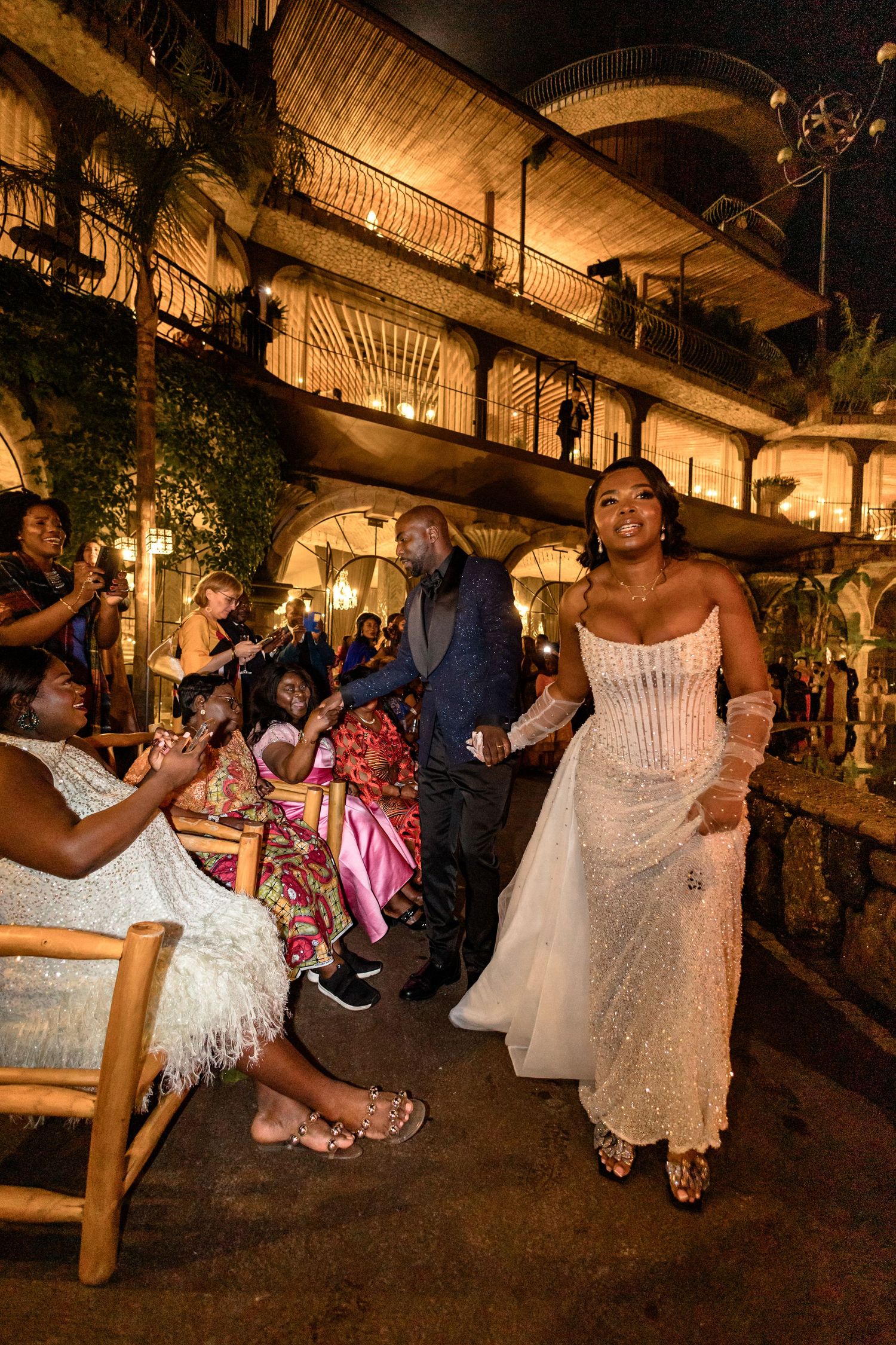 Wedding celebration in an atmospheric venue with string lights and tropical decor.