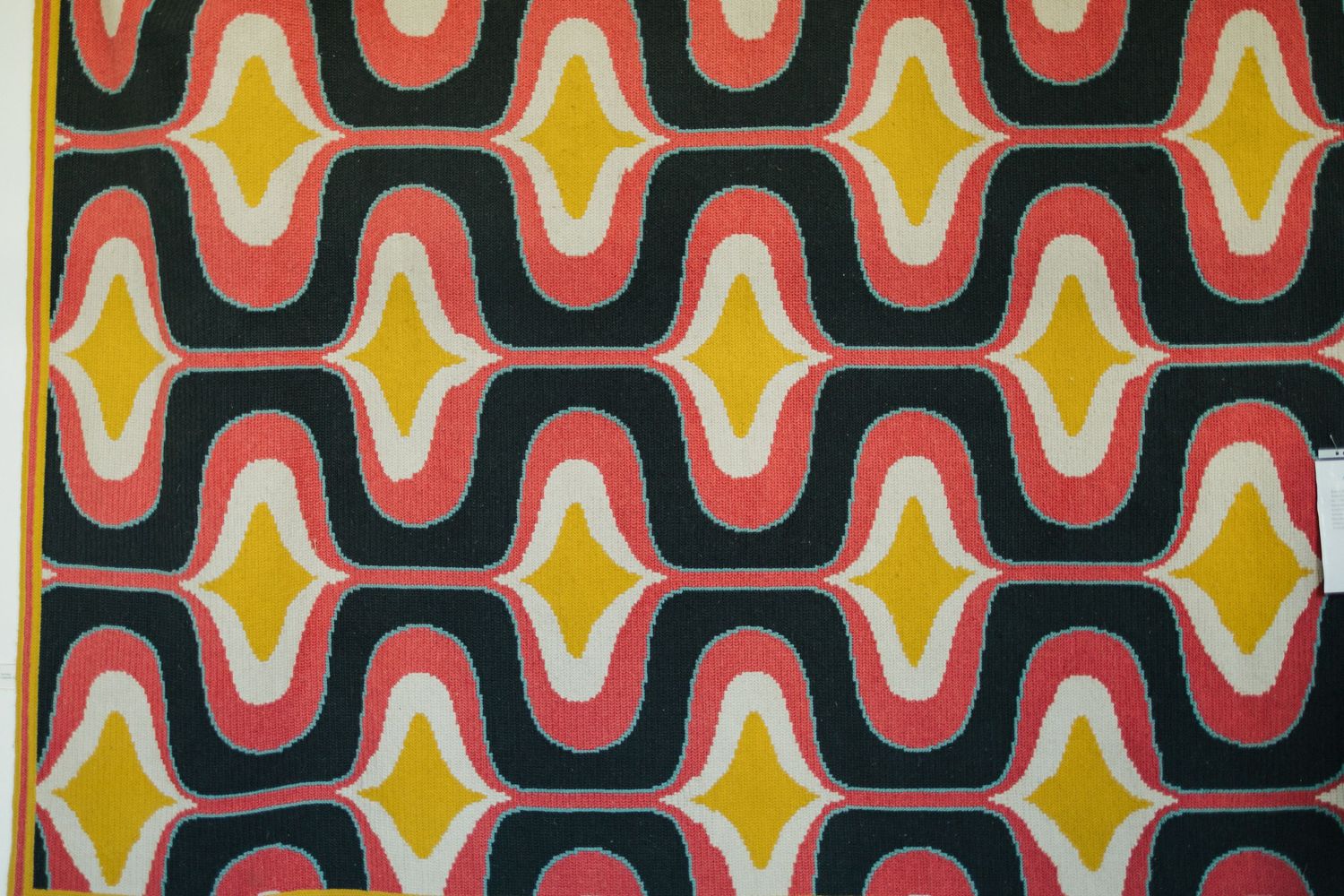 Colorful geometric pattern with orange and yellow shapes creates retro wallpaper design.