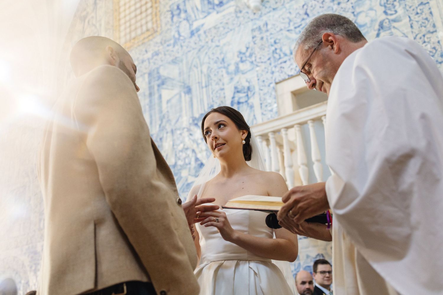 Wedding ceremony taking place in historic Portuguese chapel with stunning blue tile murals.