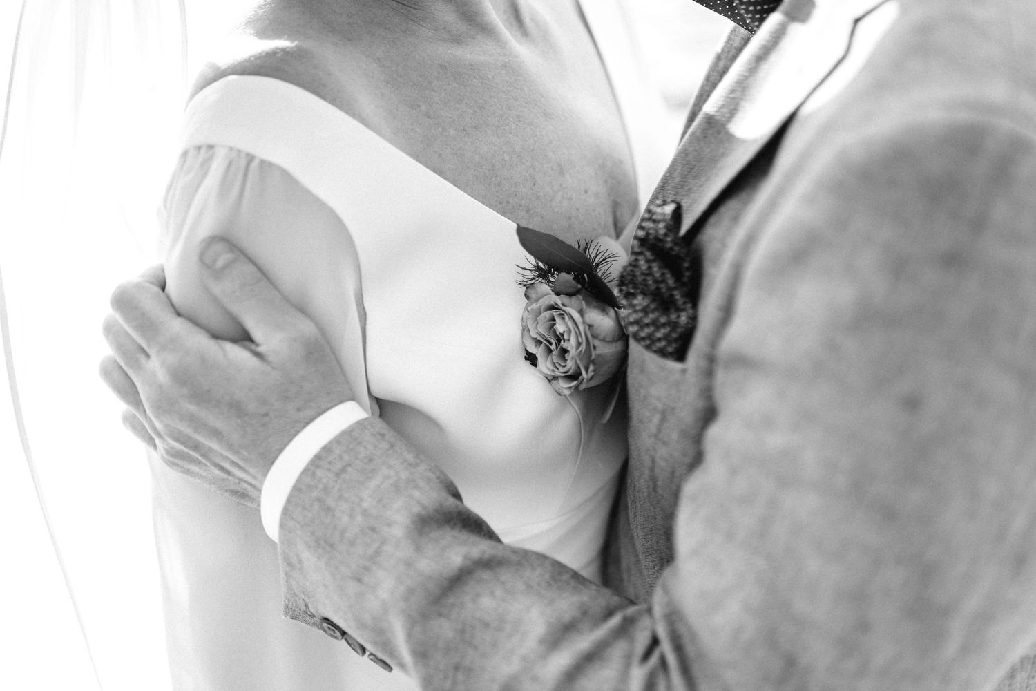 Close-up black and white shot of tender wedding moment.