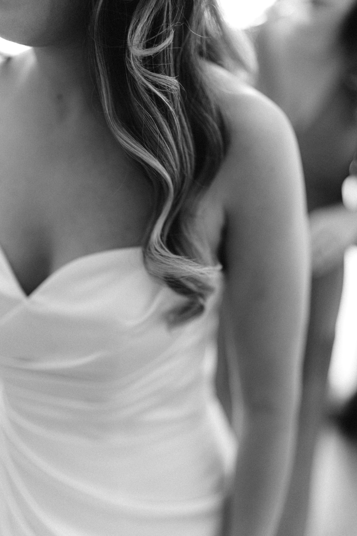 Artistic black and white sequence highlighting details of strapless wedding gown.