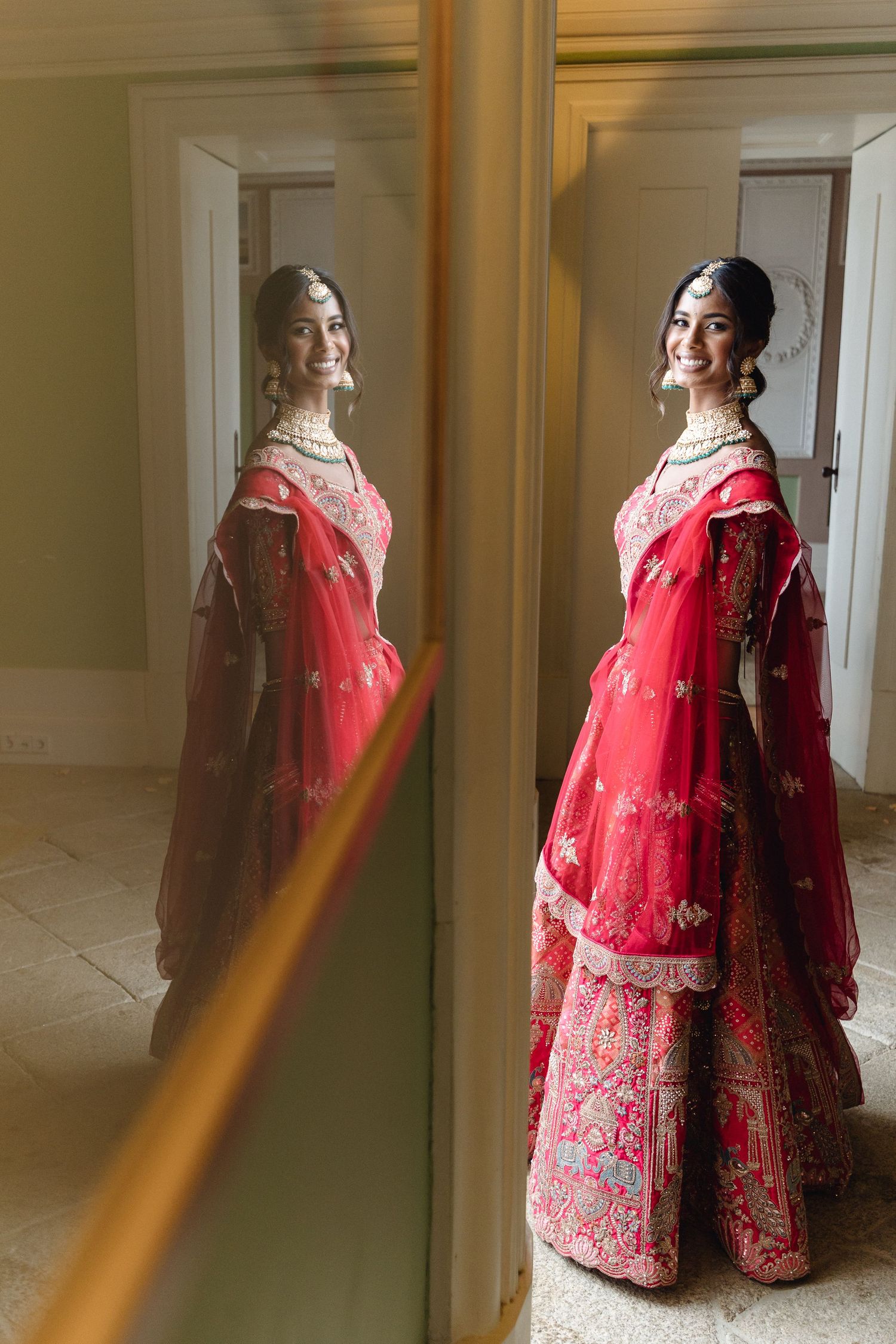 An elegant red bridal lehenga with intricate gold embroidery captured in natural window light.