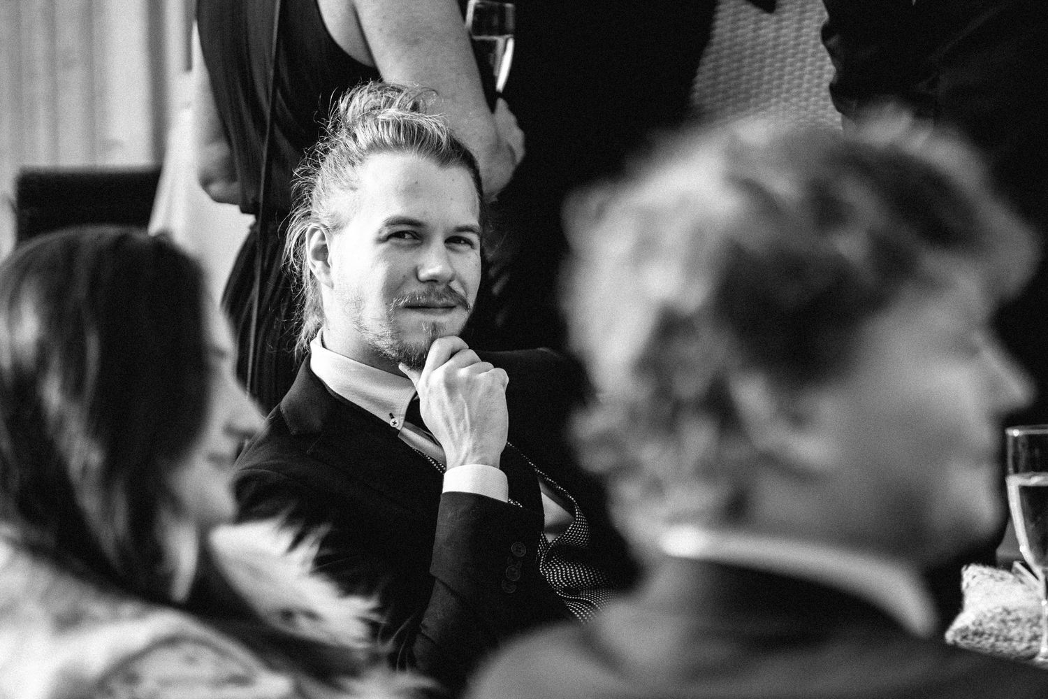 Black and white candid shots capture emotional moments during a wedding celebration.