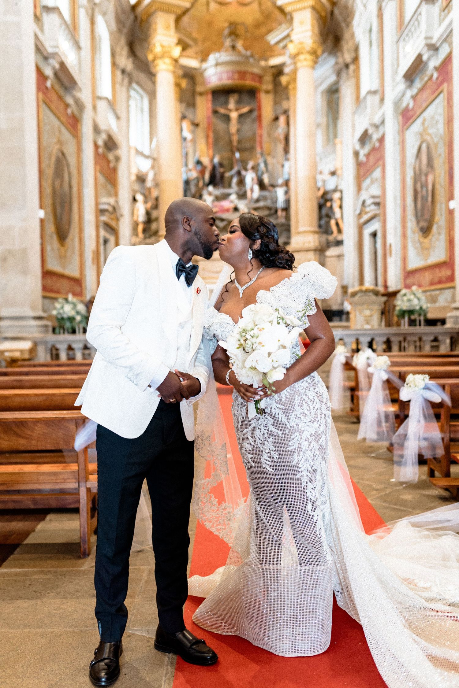 Romantic wedding ceremony moments captured in an ornate cathedral with elegant decorations.