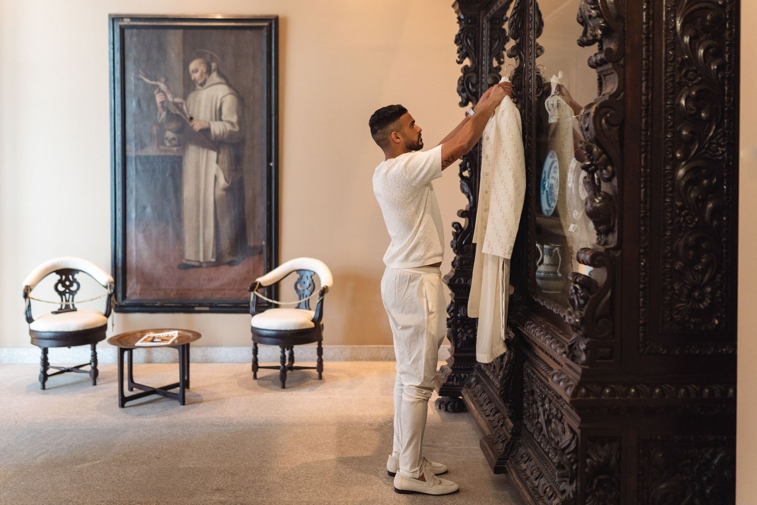 Multiple fashion poses captured in sequence against a beige wall with decorative black frame.