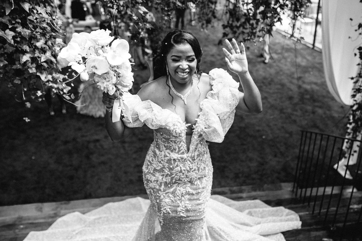 Outdoor wedding celebration with natural lighting and romantic garden setting.
