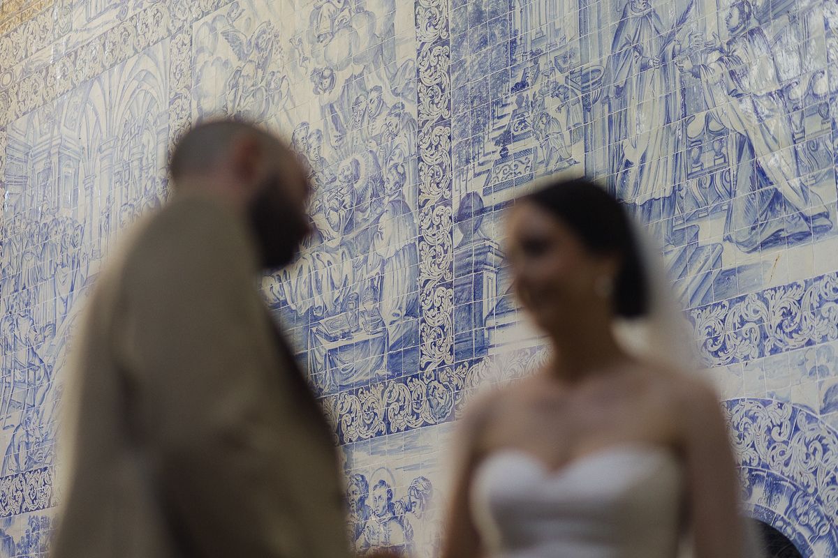 Wedding venue with blue and white tiled walls showing guests gathering.